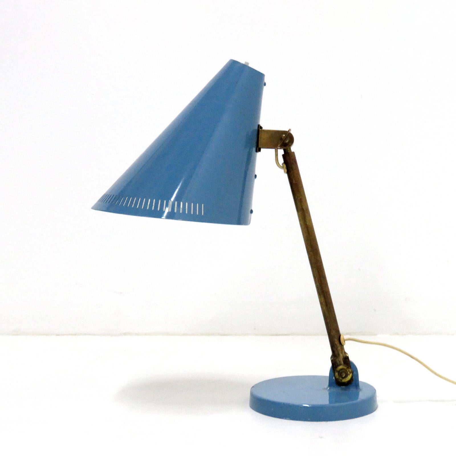 Wonderful early desk lamp model 5305 by Paavo Tynell for Taito, Finland, in brass with a large articulate light blue colored enameled shade and base, the shade is partially perforated and the brass arm is adjustable, stamped OY Taito 9222 at the