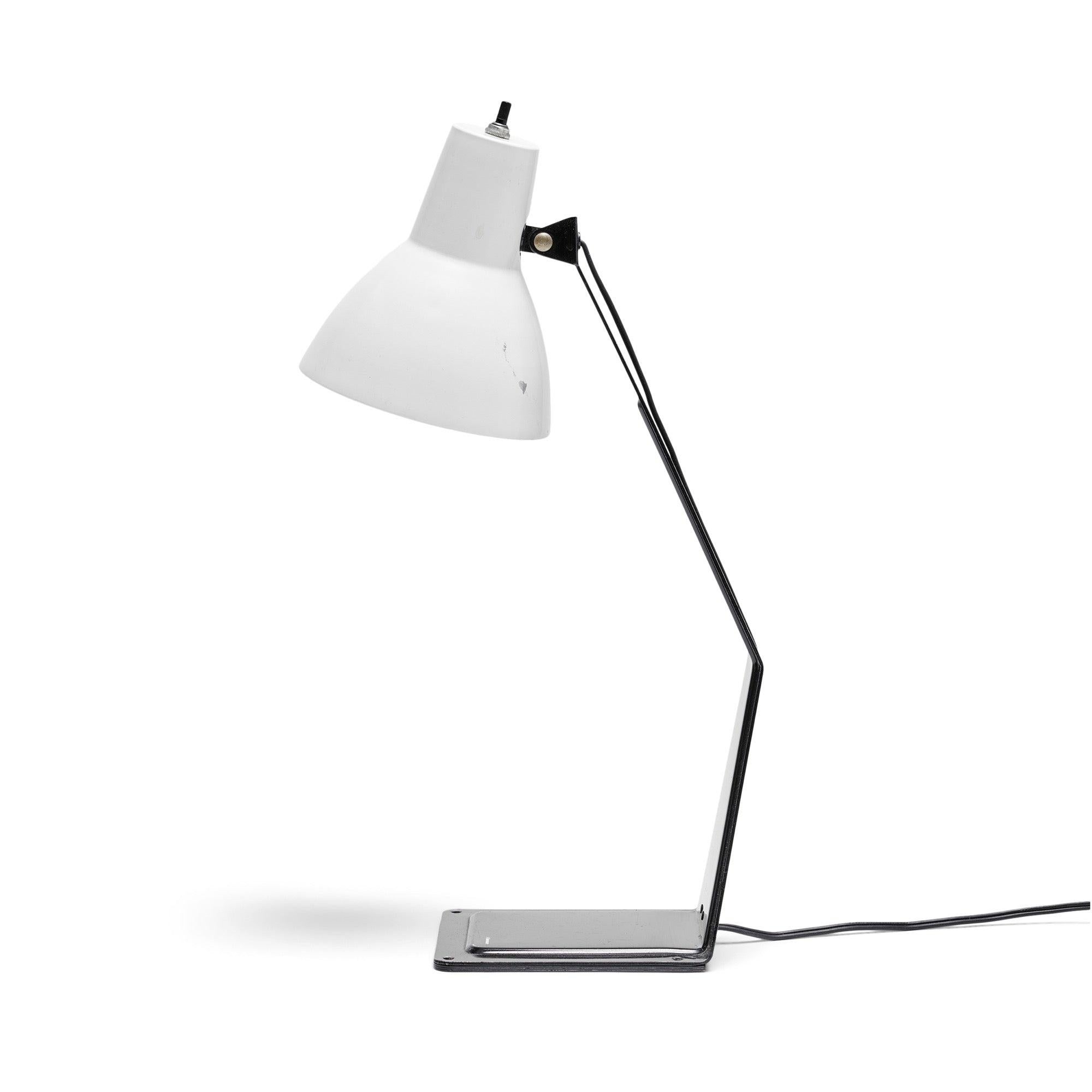 A desk / table lamp made of a singular stamped, die cut and folded piece of metal with a pivoting shade.