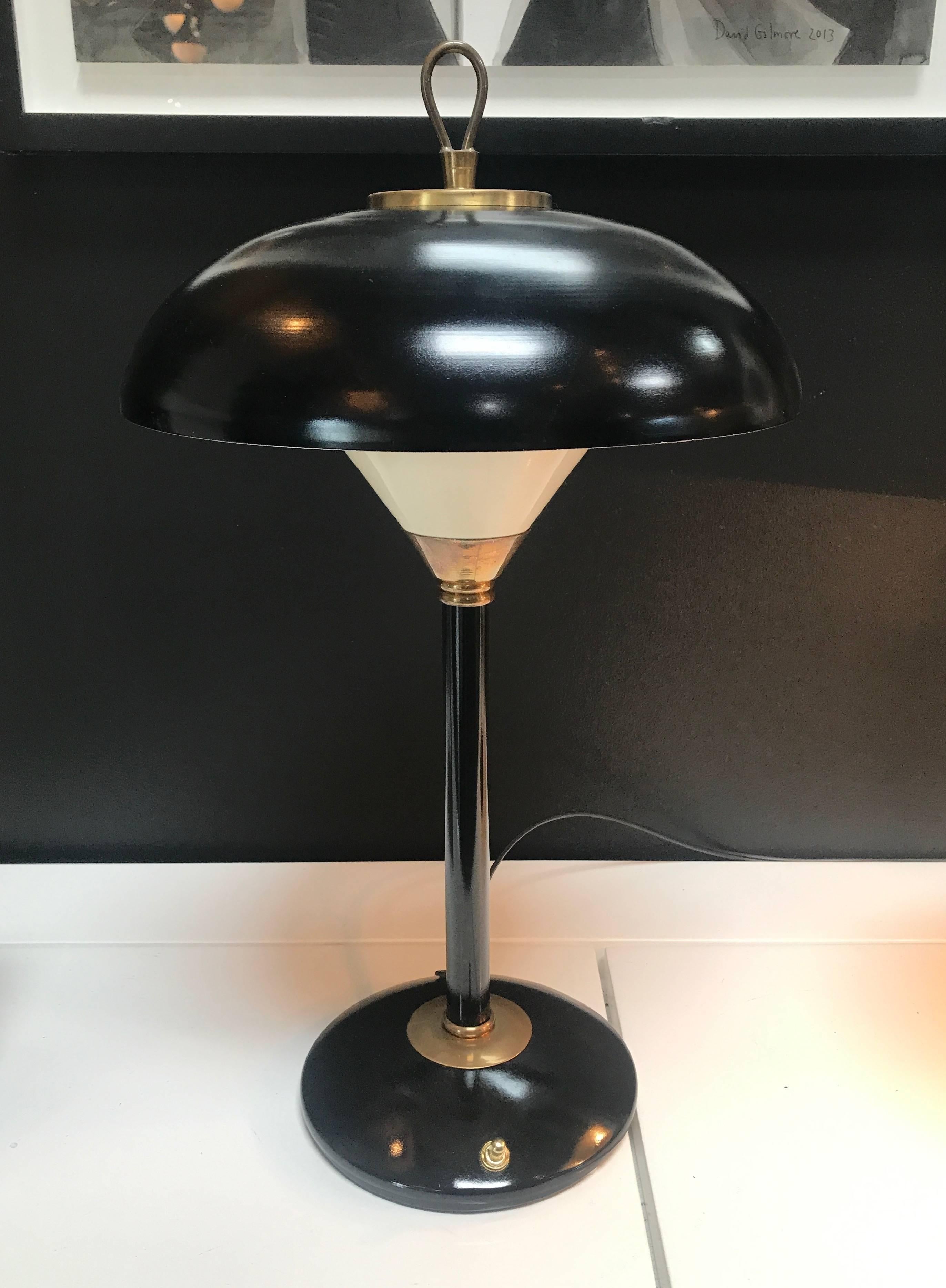 Midcentury Italian brass desk lamp with a black lacquered metal dome.