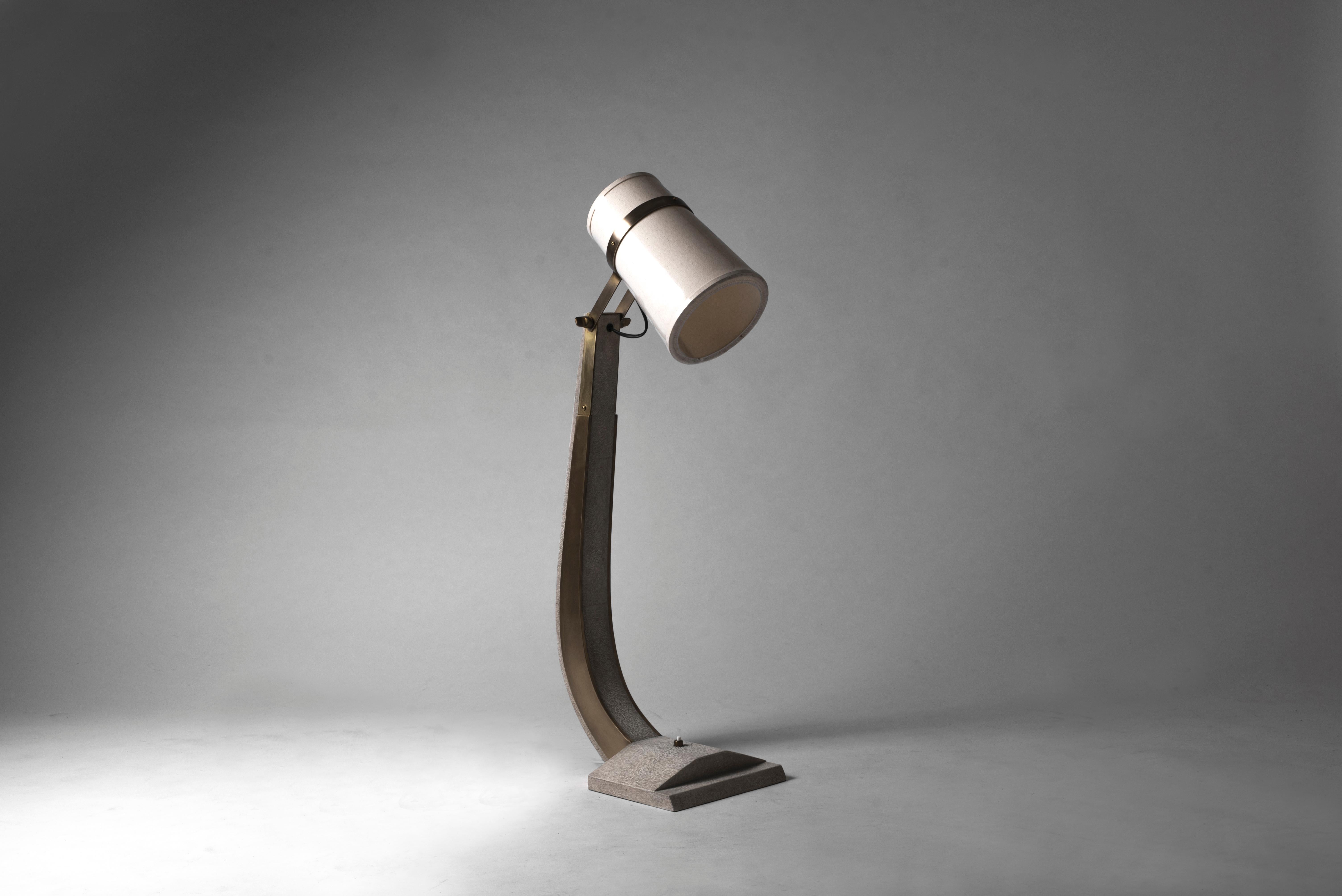 The desk lamp in cream shagreen and bronze patina brass by R&Y Augousti is a beautiful piece to add elegance to any tabletop. 

The dimensions of this piece are 9