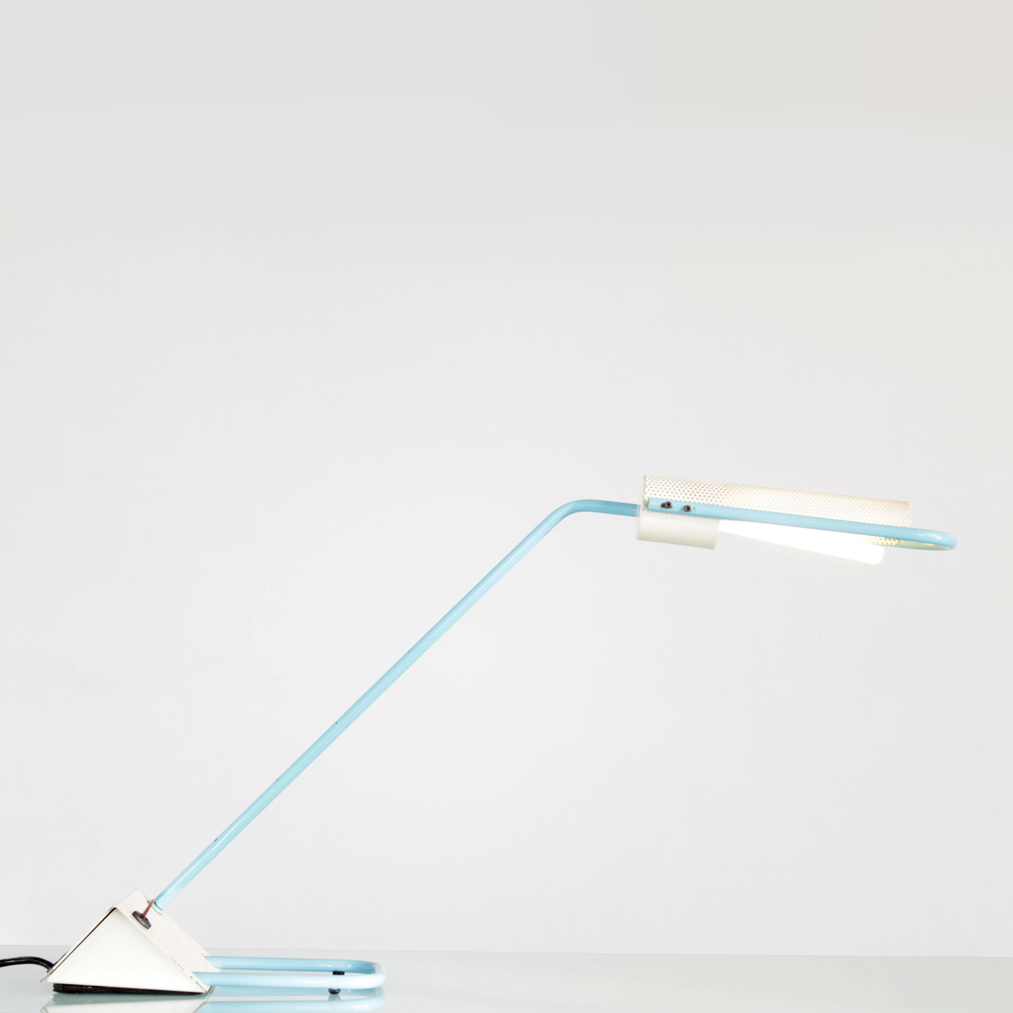 Desk lamp manufactured by Candle. The lamp has a two-tone painted metal housing, with a perforated plate in the area of the bulb.

Feel free to contact us for more detailed pictures.