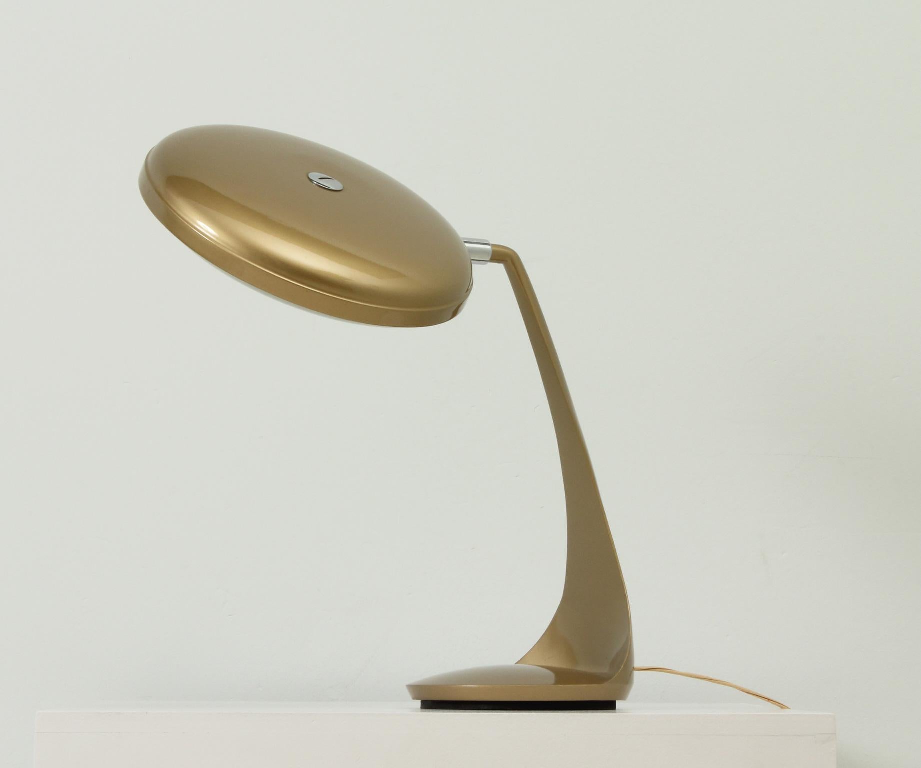 Desk lamp model Reina edited by Lupela, Spain, 1960's. Base and rotary shade enamelled in metallic gold paint with glass reflector underneath shade.