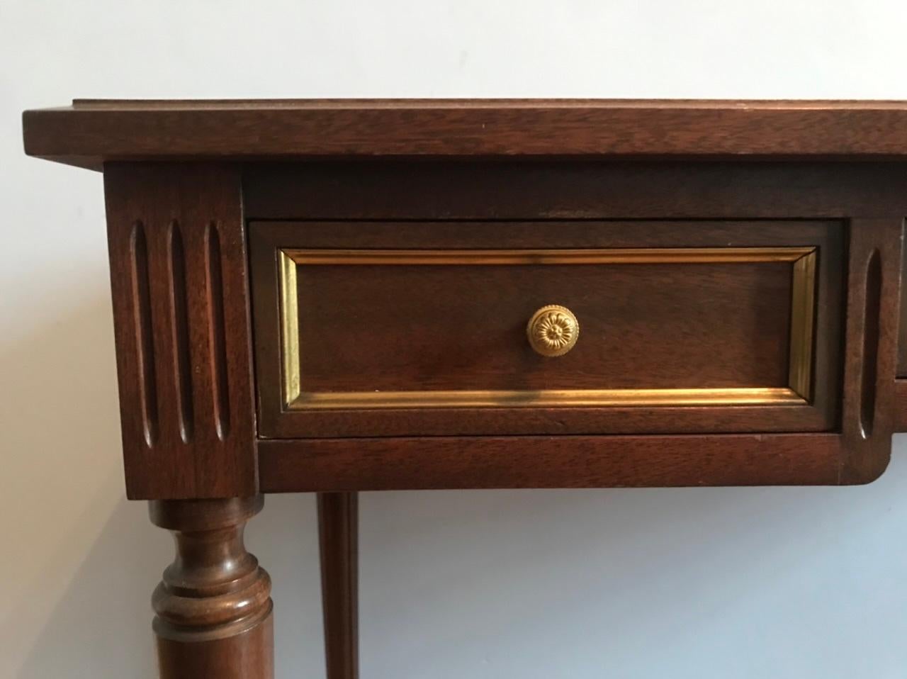 Charming little Louis XVI style desk.

Leather upper with gold floral interlacing. Composed of three drawers with interior in red velvet. The drawers are enhanced with a gilt metal rod. The handles of each drawer are in the shape of flowers in