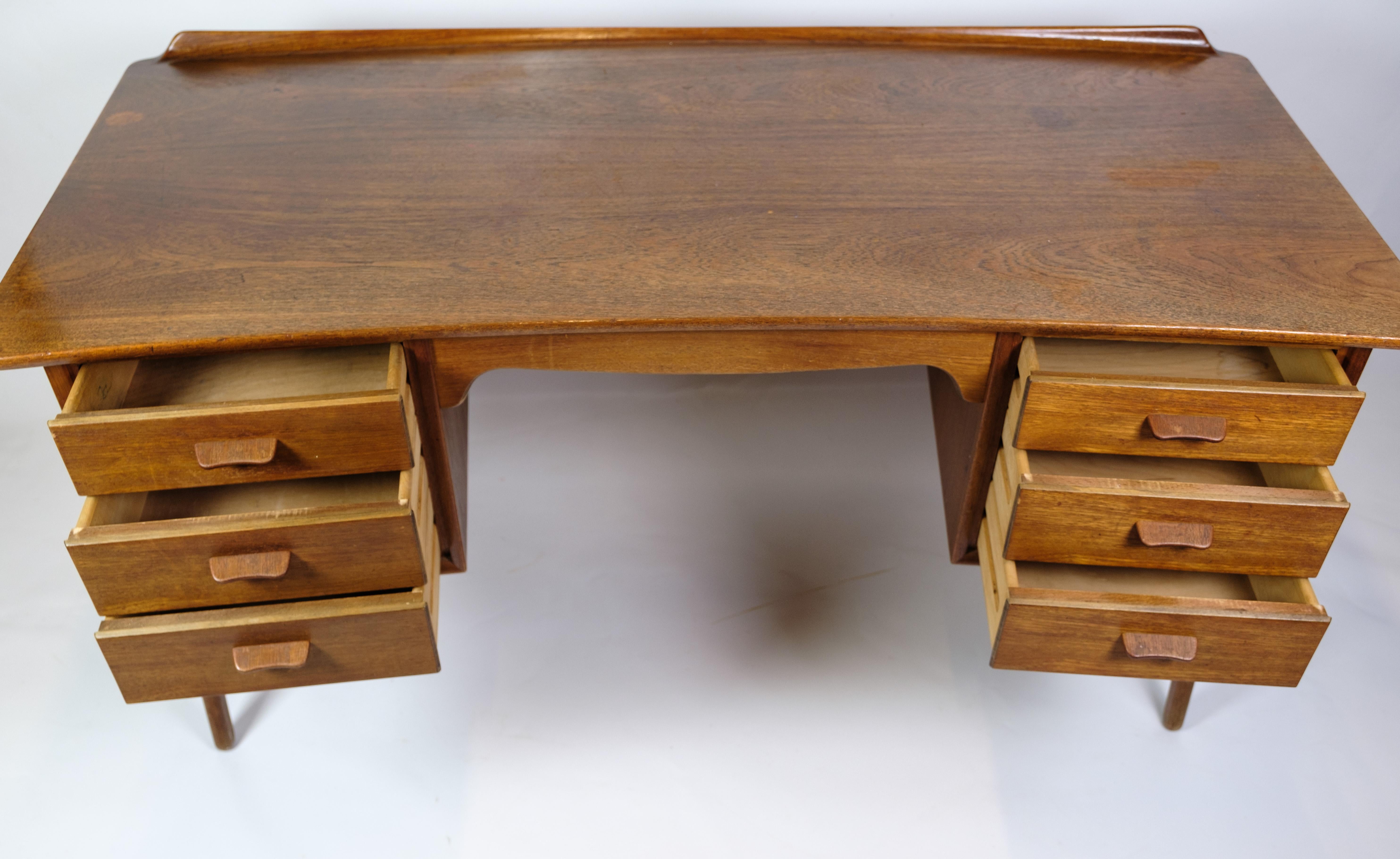 Modern 1960s teak wood desk with 3 drawers on each side designed by Svend Aage Madsen and manufactured by Sigurd Hansen from around the 1960s. High quality desk with shelf at the back for extra storage or the option of placing it in an open space.