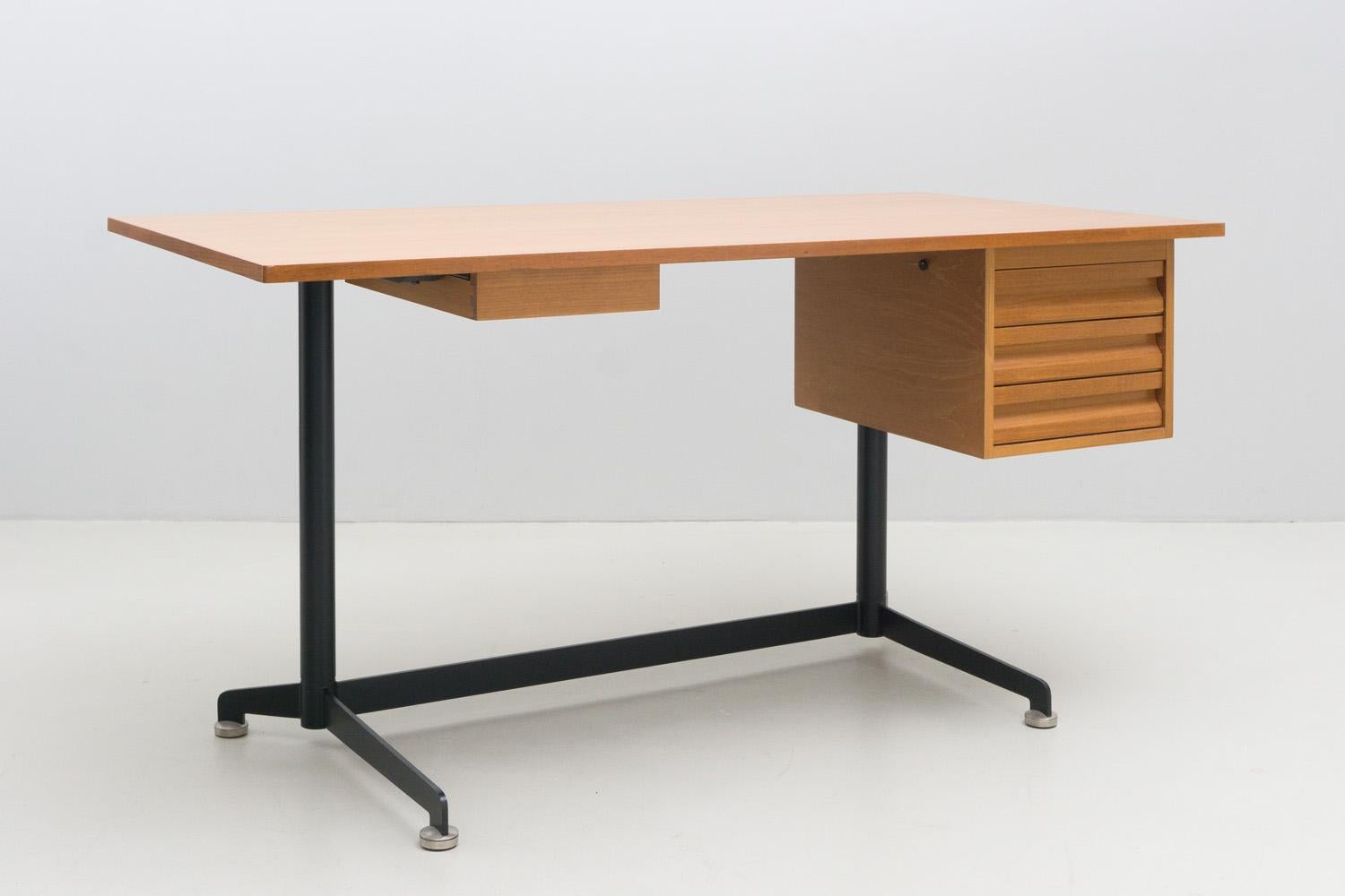 Chique and minimal, rare desk designed by Osvaldo Borsani in 1956 and manufactured by Tecno Italy. 
the plate and the drawers are made of walnut wood, its construction is made of black lacquered metal. this is a variant of the “T96” model, from the