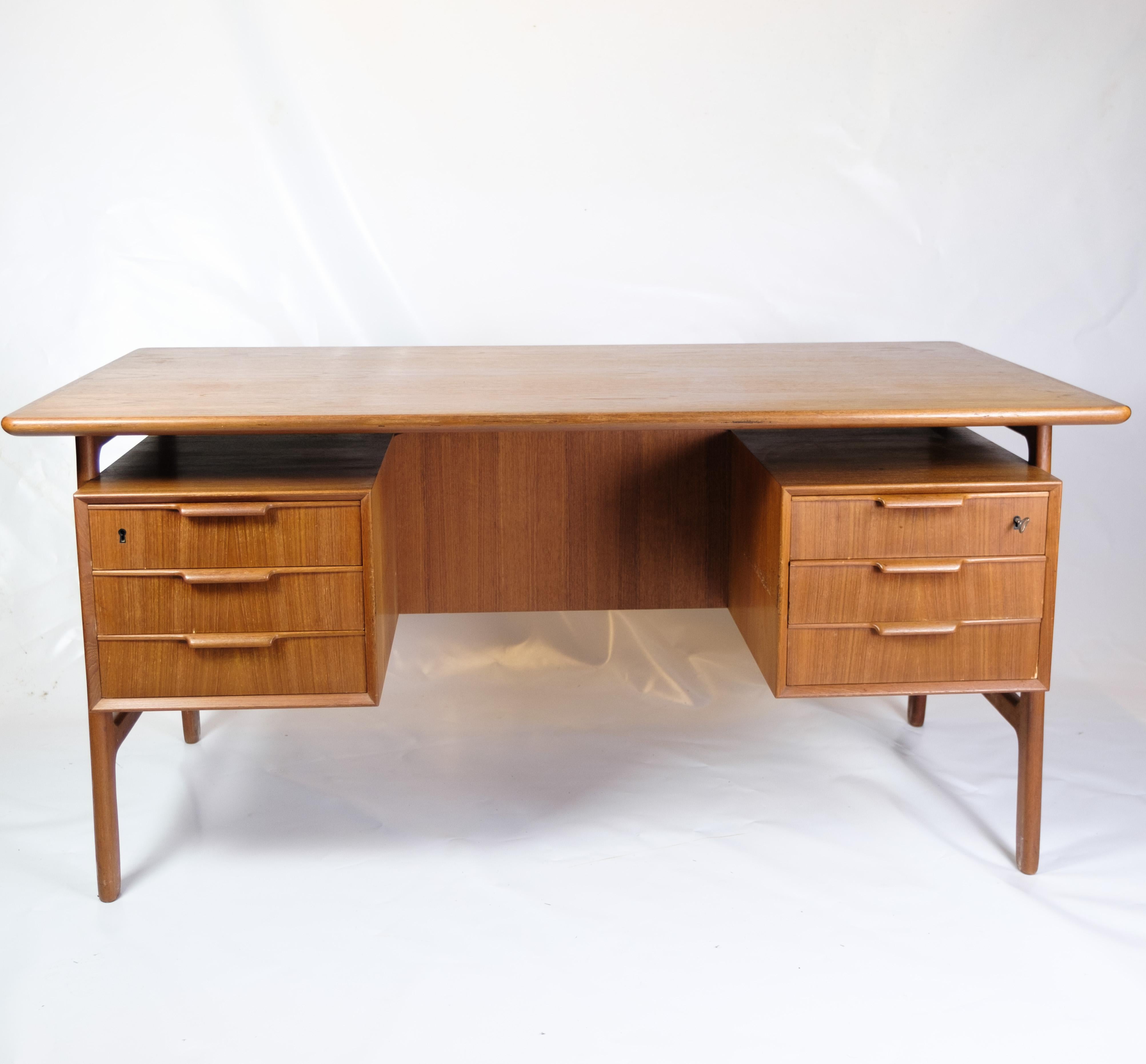 This desk, known as Model 75, is an excellent representation of Danish furniture craftsmanship from the 1960s. Produced by Omann Junior Møbelfabrik, a renowned company with a history of quality and innovation, the desk is an example of their