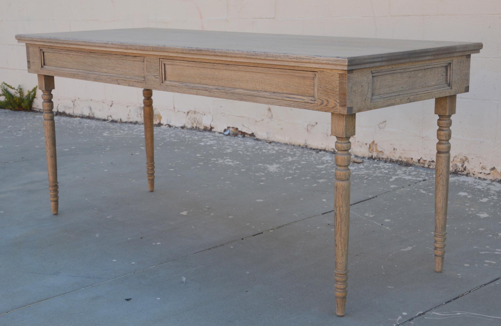 This rift sawn oak desk has turned legs and two drawers. It is seen here in 68