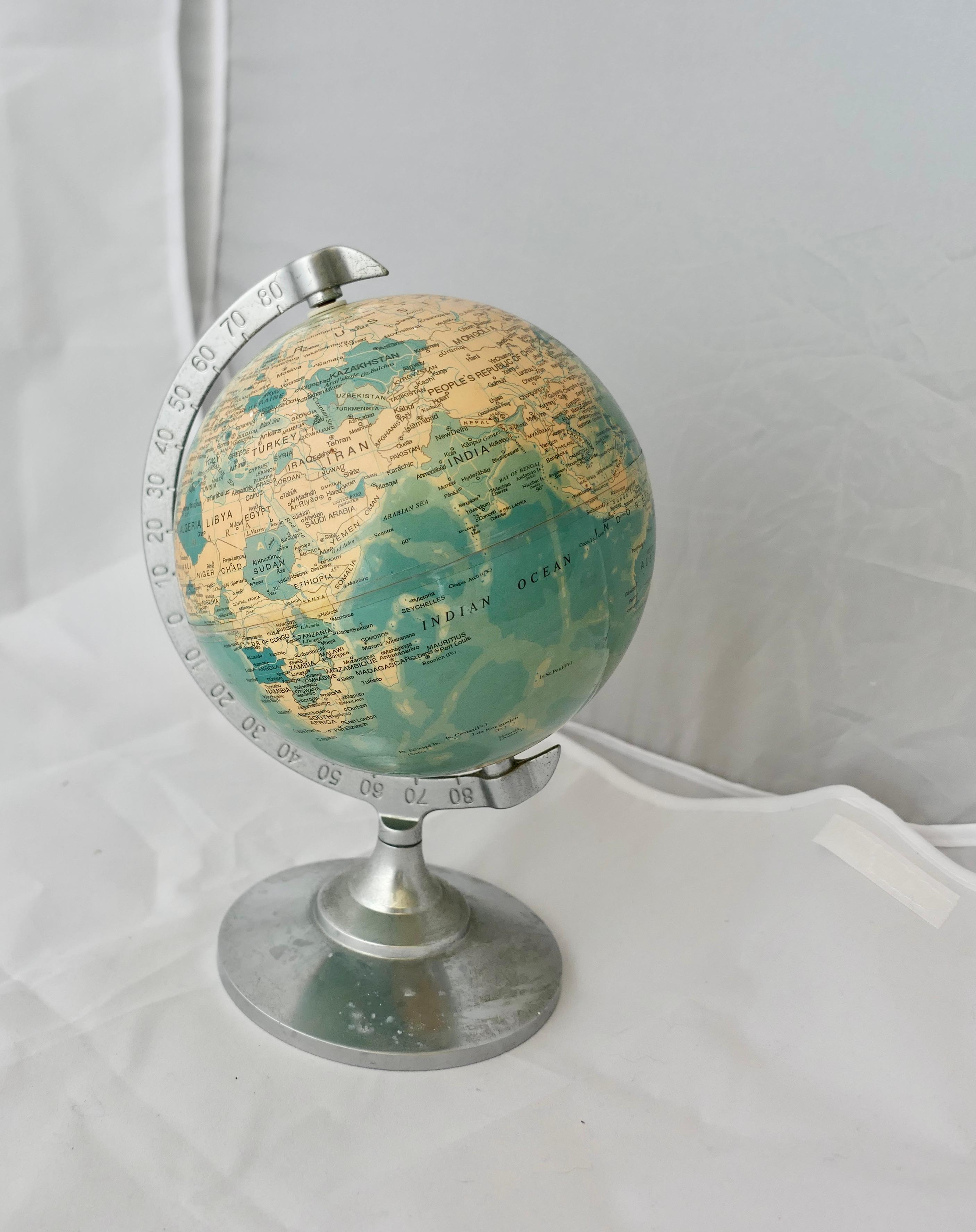  Desk Ornament World Globe with Chromed Stand

A super piece and a useful desk ornament for the desk that has everything else 
This small globe is set on a chrome stand, in good condition a great piece, the globe is 9” high and 5” in diameter
FB200