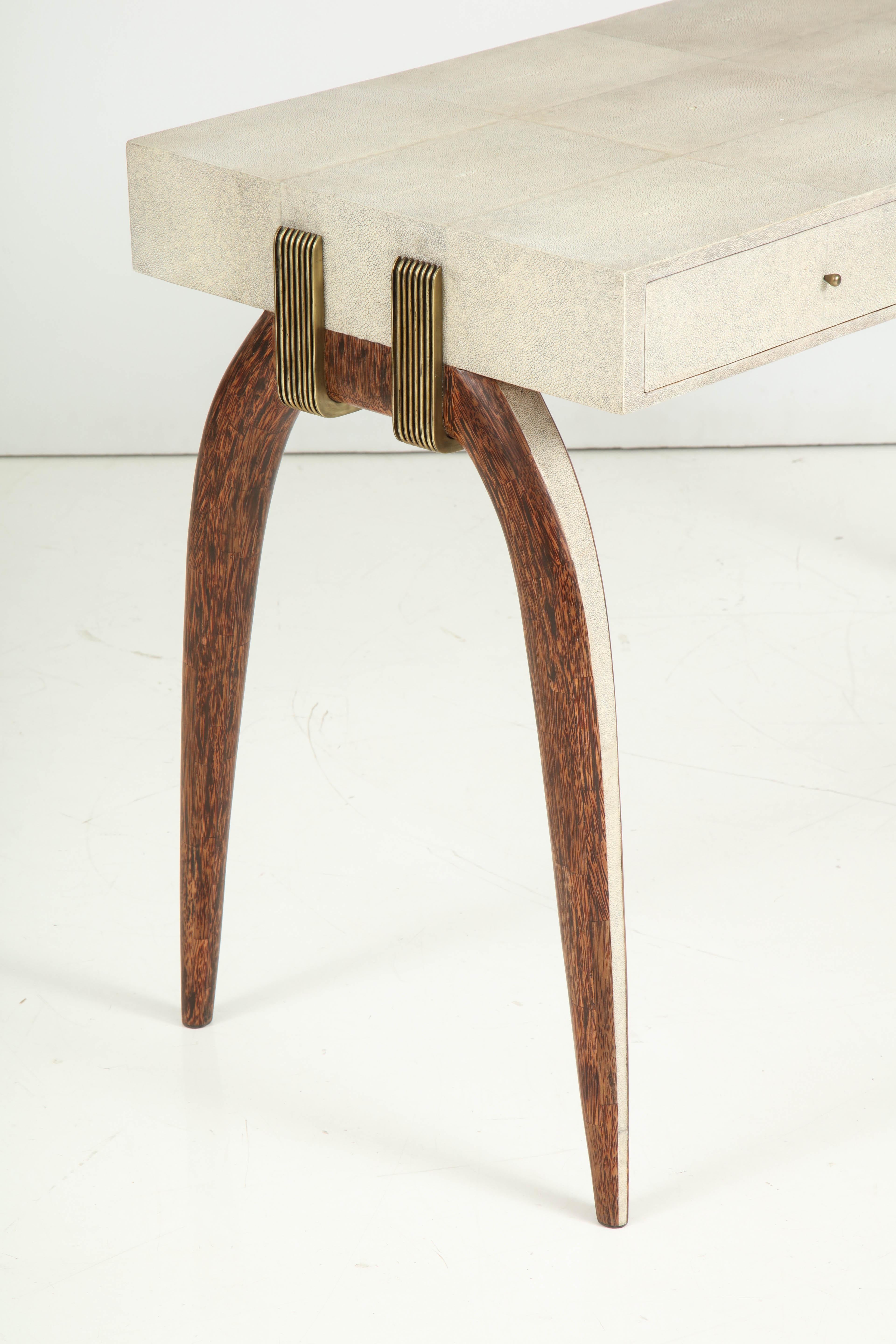 Decorative shagreen desk with palm wood and brass details. The desk is finished all around. 
Desk legs are beautifully curved with palm wood and shagreen. The desk has a brass design on each side which is going around the legs and up onto the top