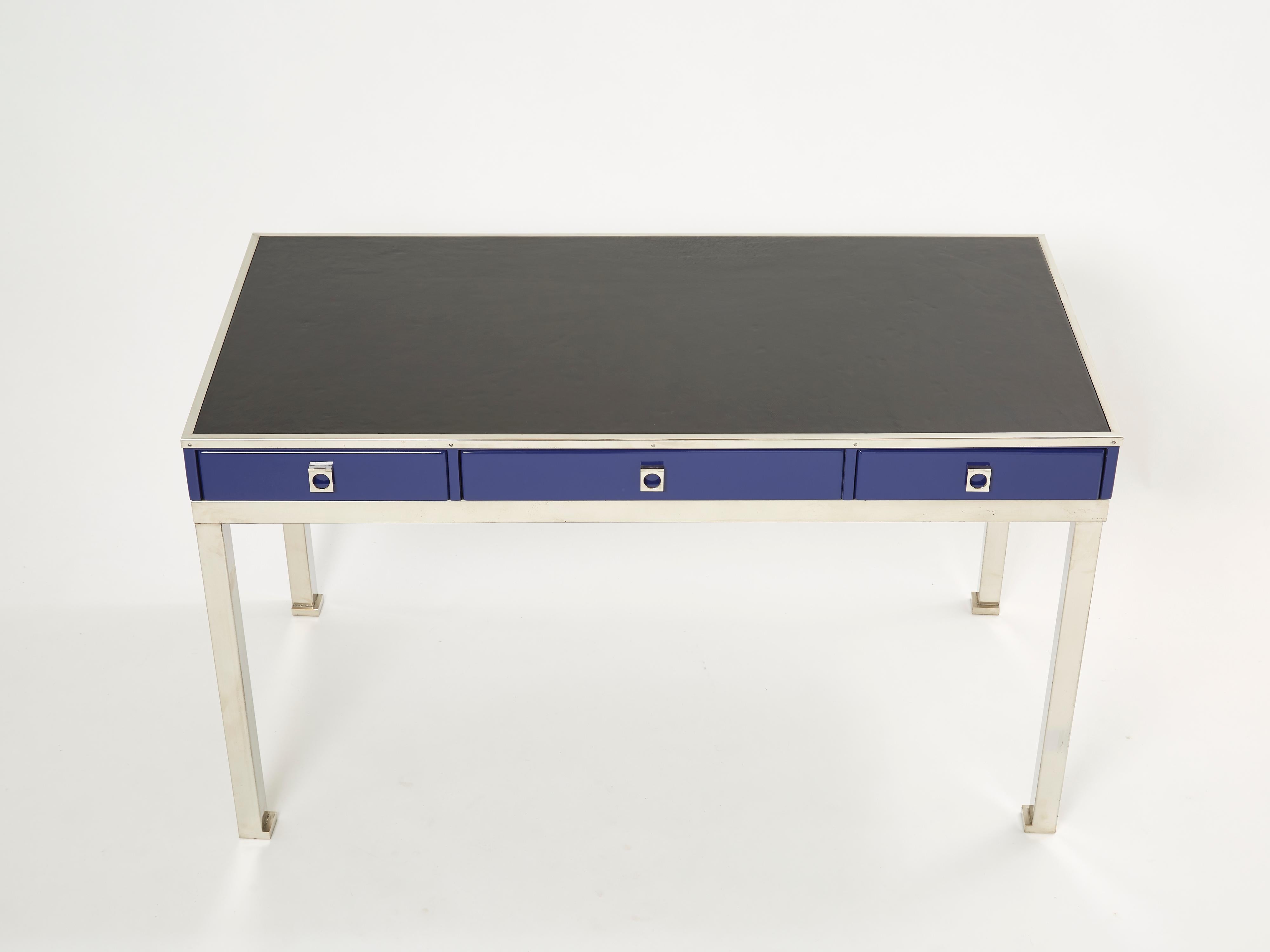 A rare Maison Jansen blue lacquered desk table designed by Guy Lefevre, it features a simple side black leather top surface and three drawers. Following the glamorous French Mid-century look of other Classic Guy Lefevre designs, this beautiful desk