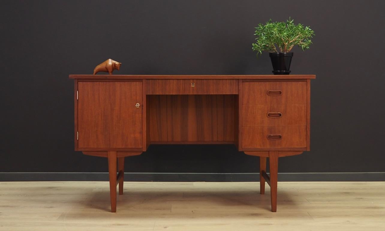 Fantastic desk from the 1960s-1970s, Danish design, minimalistic form. Furniture finished with teak veneer, legs made of solid wood. Desk has four drawers and a capacious chest of drawers. Key in the set. Maintained in good condition (minor bruises