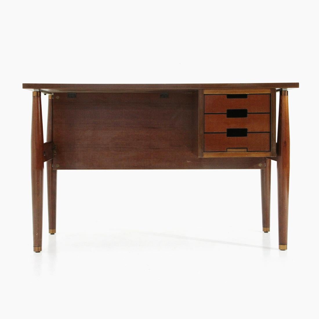 Desk produced in the 1960s by Schirolli.
Structure in wood, tips in brass.
Plastic drawers with wood veneer front.
Formica veneered wood top.
Good general condition, some signs due to normal use over time, signs of the screws on the front