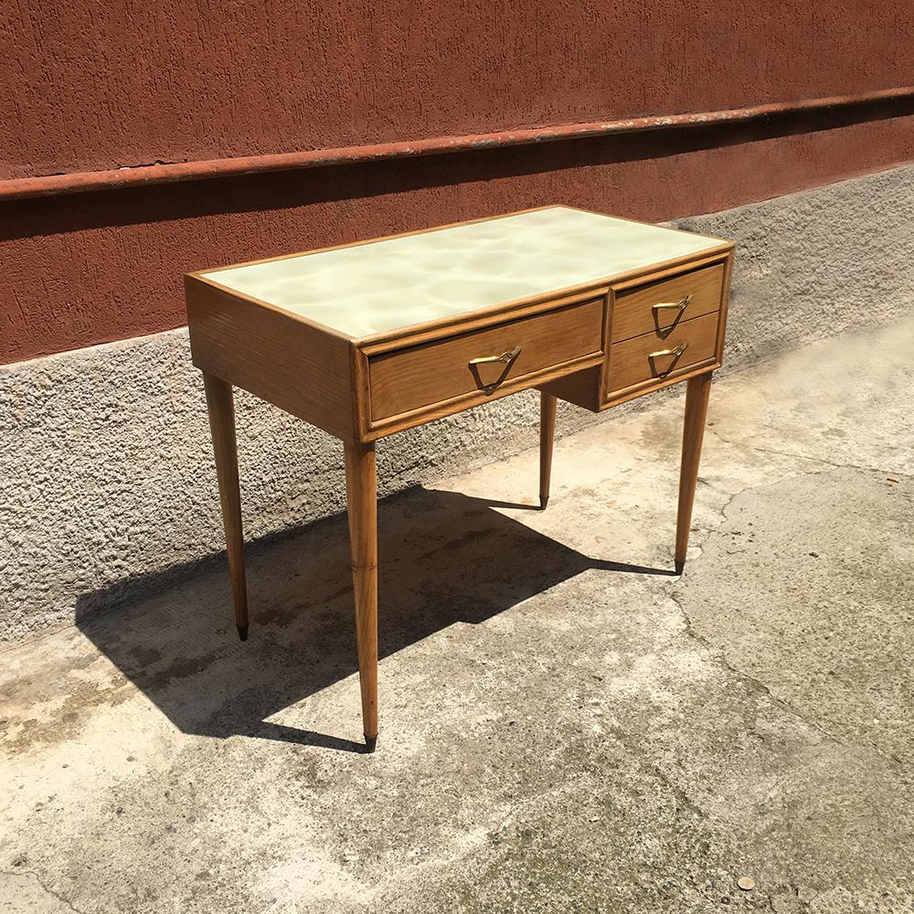 Desk with drawers from 1950s, with a light wood structure and turned legs and a marble-effect painting below the glass top with brass tips and handles, One deep drawer instead of two smaller.
Good conditions.