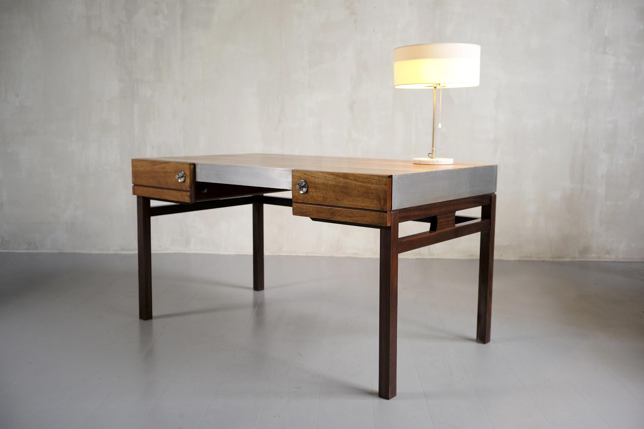 Desk with two drawers, French work 1960. Base in solid mahogany, box veneered with aluminum leaves and top in walnut veneer. With a refined elegance, this desk can be placed in the middle of a room. Very good condition.