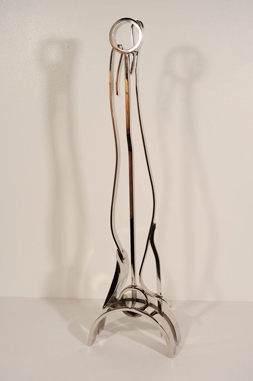 Modernist set of polished nickel fireplace tools in the manner of Donald Deskey. Set includes stand, poker, and shovel.