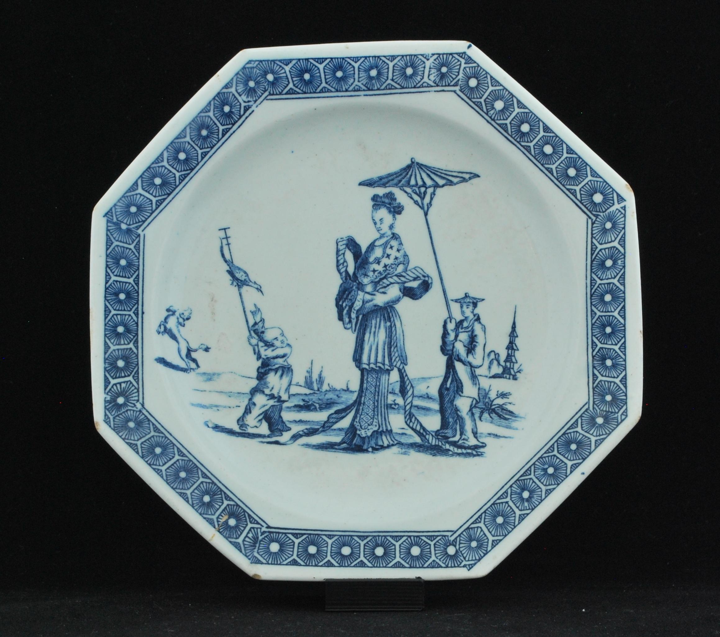Plate, circa 1758-1760: 

Small octagonal plate, the well printed in blue underglaze with La Dame Chinoise (also called the Promenade Chinoise) showing a tall oriental lady with two boy attendants, one shading her with a parasol, the other