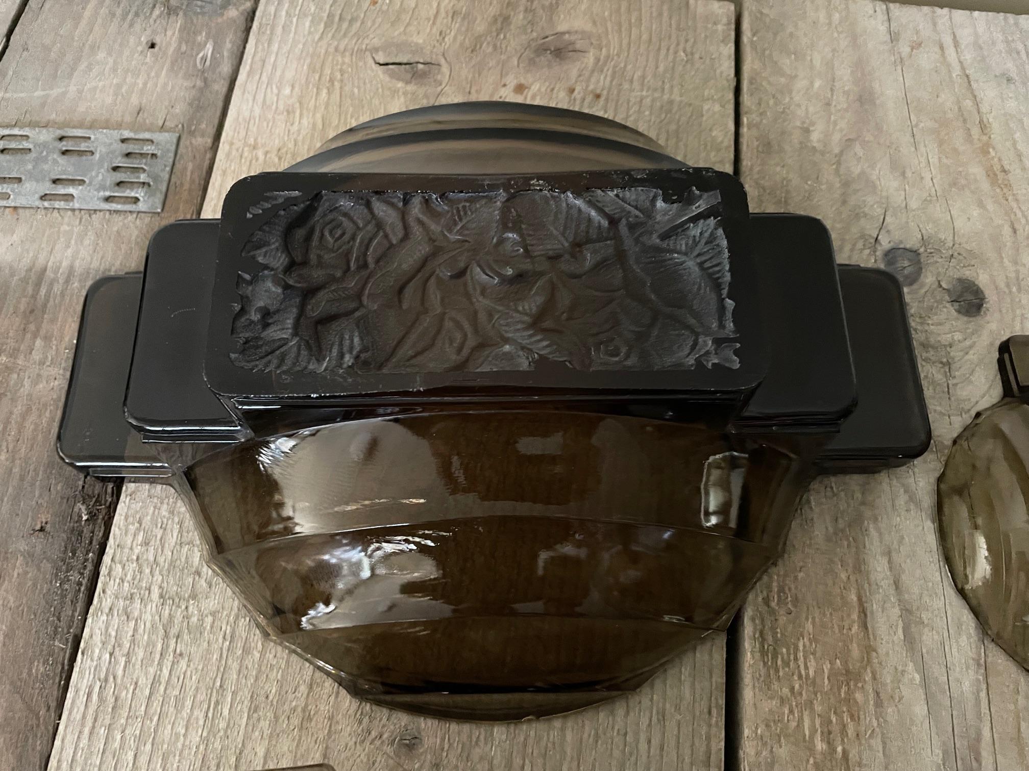 Molded pressed smoked glass dessert service with a flower design on the back in each piece of this service.
it is from the art deco period.