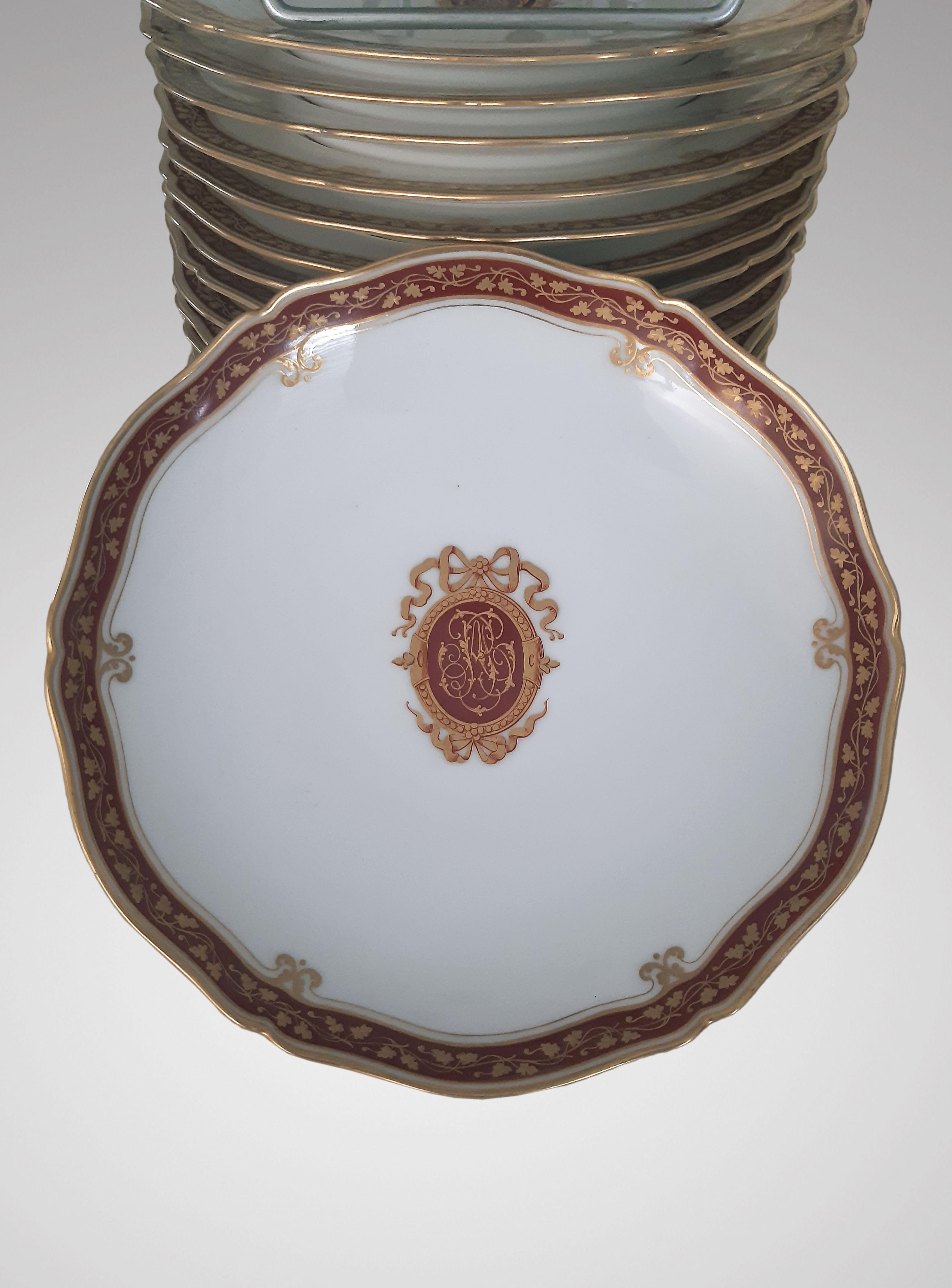 Le Rosey XI rue de la Paix Paris, dessert service in white porcelain with gold decoration on a brown background with a monogram surrounded by a ribbon in the center and a frieze of vine branches around the edge.
Comprising: 18 plates, two displays,