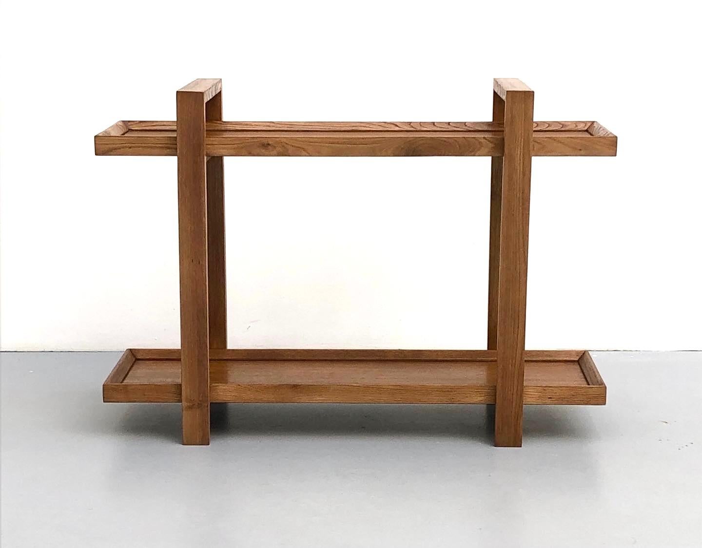 Console/Dessert Table made by René Gabriel, 1940

The object consists of two arches connected by two trays, all made of oak wood. With its aesthetic simplicity and strong, decisive lines, the piece feels more contemporary than its 1940s creation