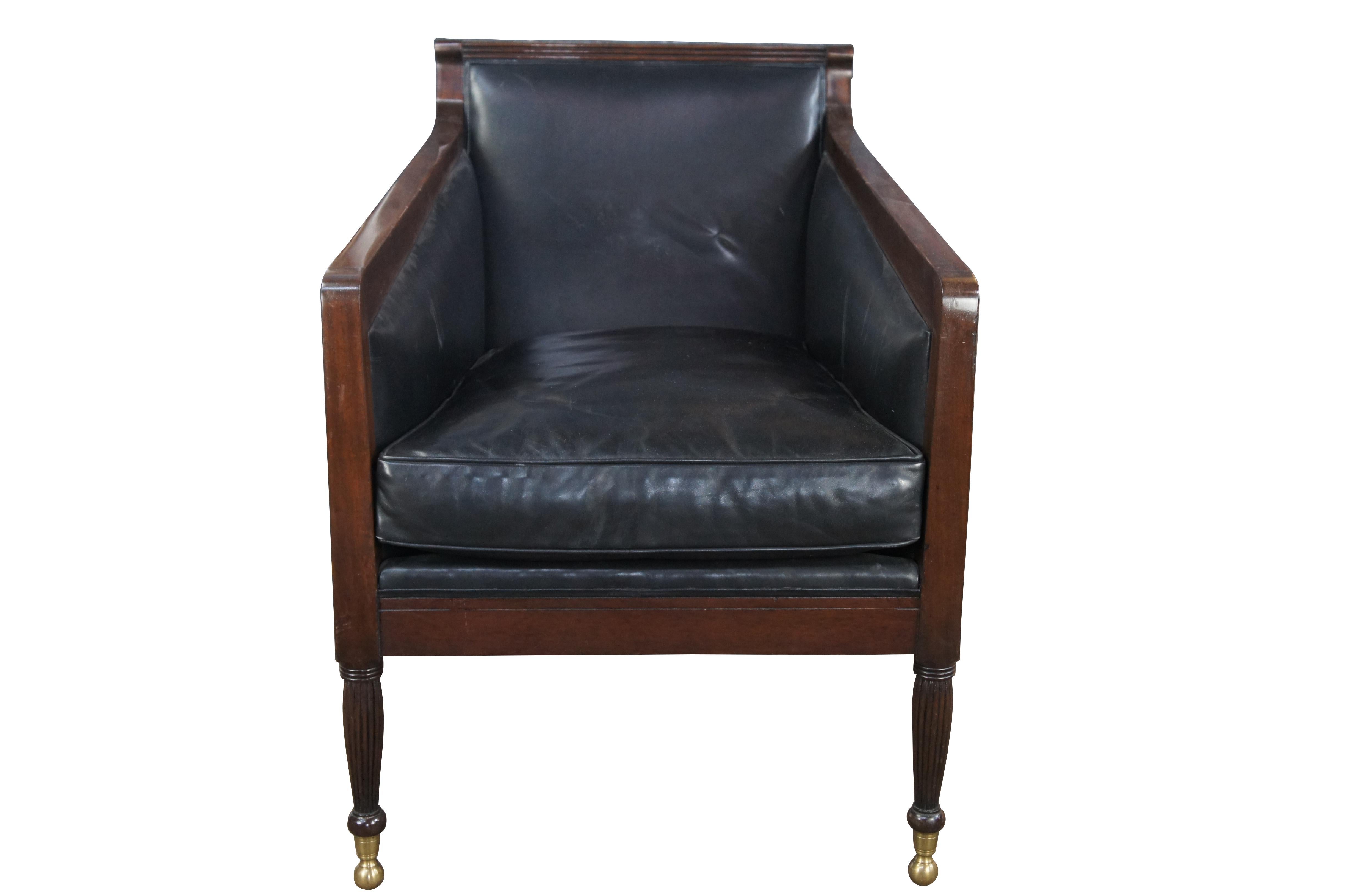 Dessin Fournir Nelson Arm Chair, Circa 2000s. Features a mahogany frame with deep plush black leather upholstered chair back and sloped arms. Includes reeded side panels and reeded legs over brass ball feet. Inspired by English Regency & Modern