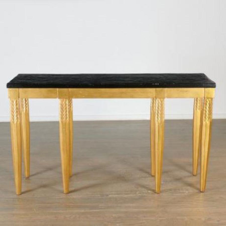 Elegant Dessin Fournir Renee Console #502; a now archived item from Fournir Collections.
Late 20th c. , American, black lacquered craquelure top over 8 gold leafed carved wood legs, label to underside. A very striking and conversation-worthy piece