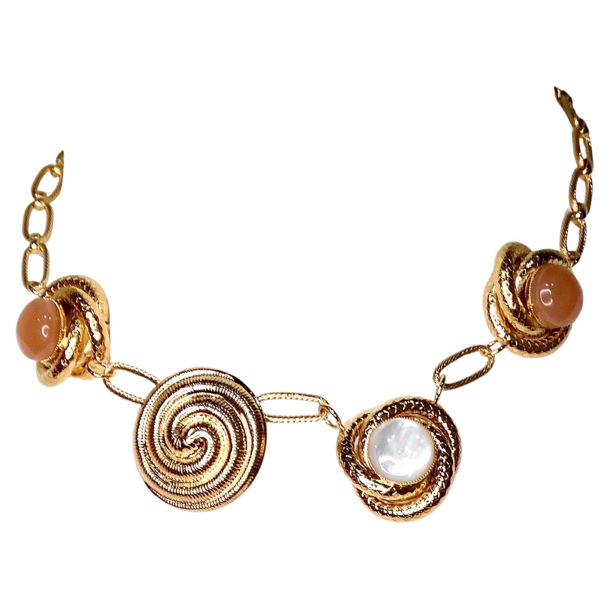 The Destree 18k Gold-Plated Costume Gemstone Chainlink Necklace is a stunning statement piece that exudes elegance and modern sophistication. Crafted with 18k gold-plated finish, this necklace features a series of pink and pearly costume gemstones
