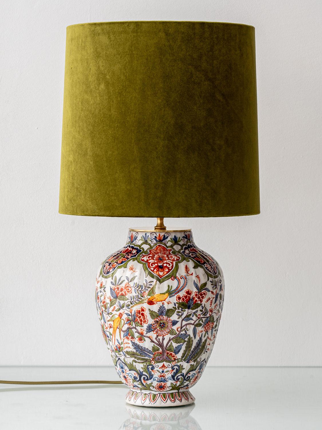 Meticulously handcrafted by Amitābha Studio in Amsterdam from a rare Desvres ceramic vase attributed to Géo Martel (circa 1900–1920), this Delft table lamp is a striking blend of historical elegance and contemporary design. The faience base, marked