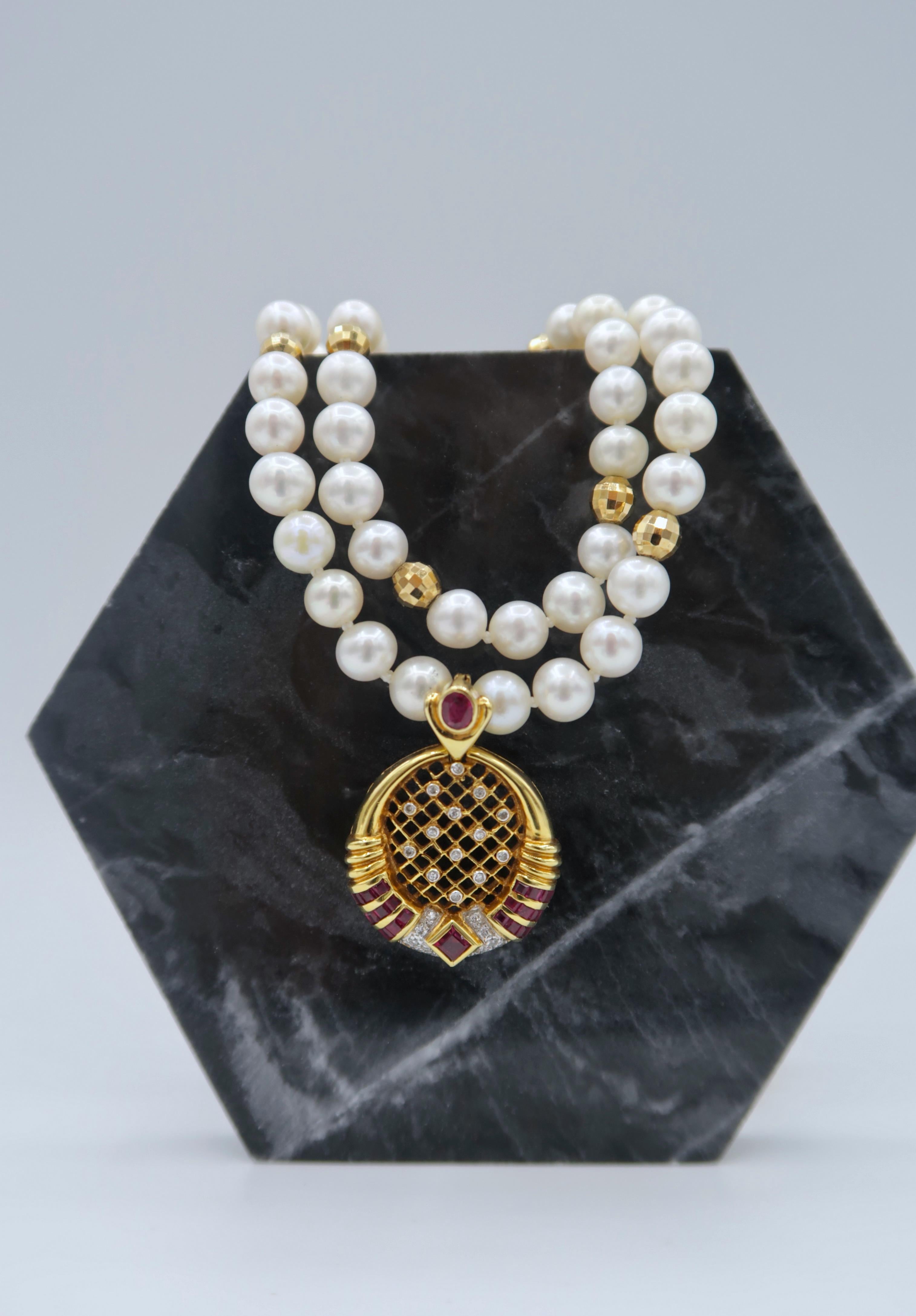 Detachable Velvety Red Ruby Diamond Perforated Medallion Pendant in 18K Yellow Gold on Double Strand Pearl Necklace with Faceted Gold Beads

Pendant
Gold: 18K Yellow Gold, 5.80 g
Ruby: 2.24 ct
Diamond: 0.20 ct

Necklace
Length: 16.5 inches
Pearl: