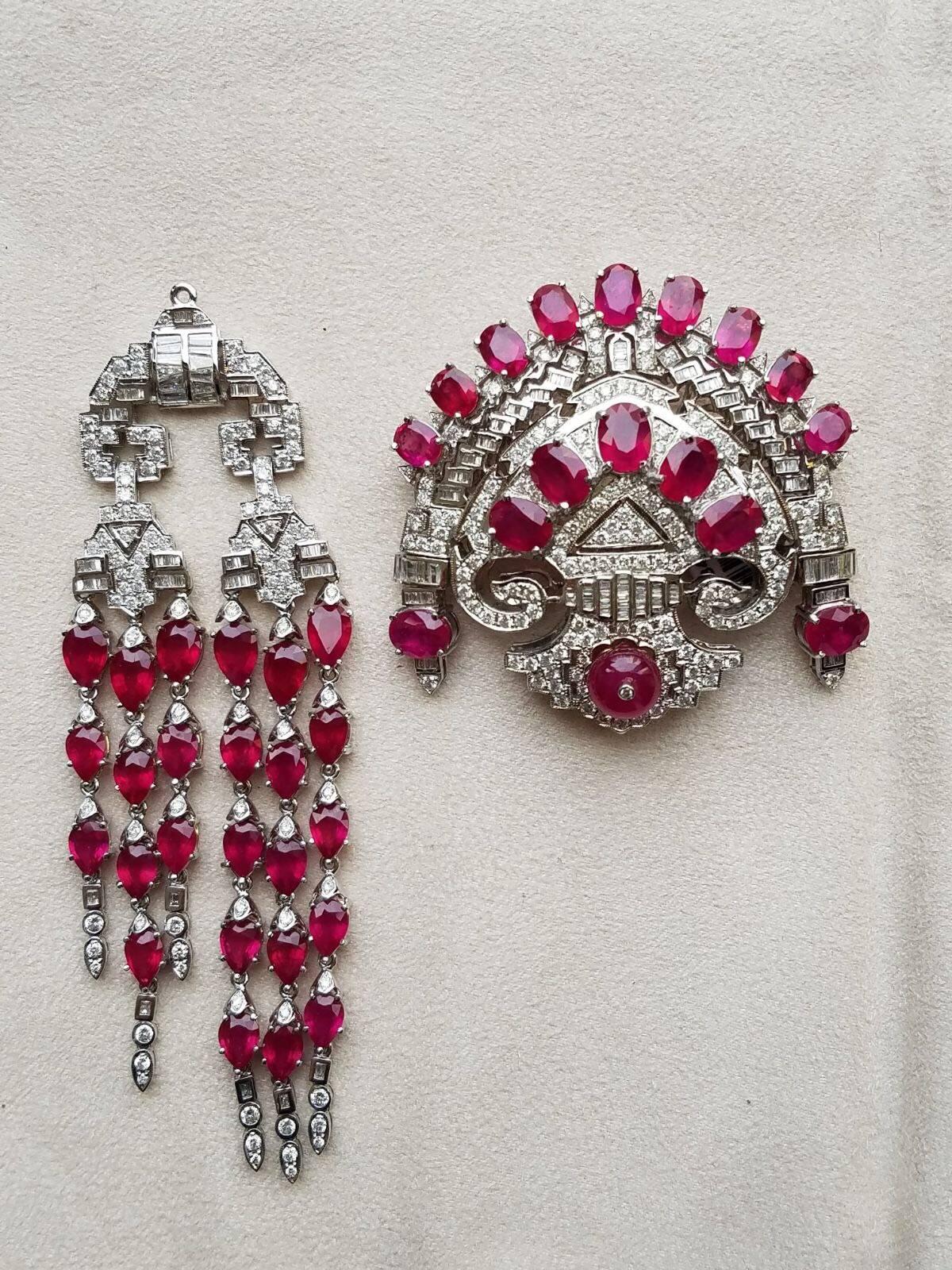 A stunning, art-deco looking clip brooch/pendant, consisting of Mozambique rubies and Diamonds. The dangling, bottom half of the item is detachable (as seen in photos). 

Stone Details:
Stone: Mozambique Ruby
Cut: Oval / bead
Weight: 53.64