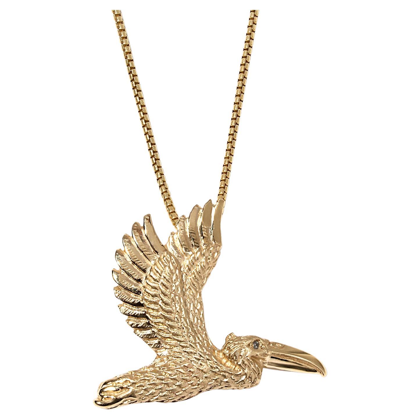 Detailed 14K Yellow Gold Pelican Pendant Necklace with Diamond Eye For Sale