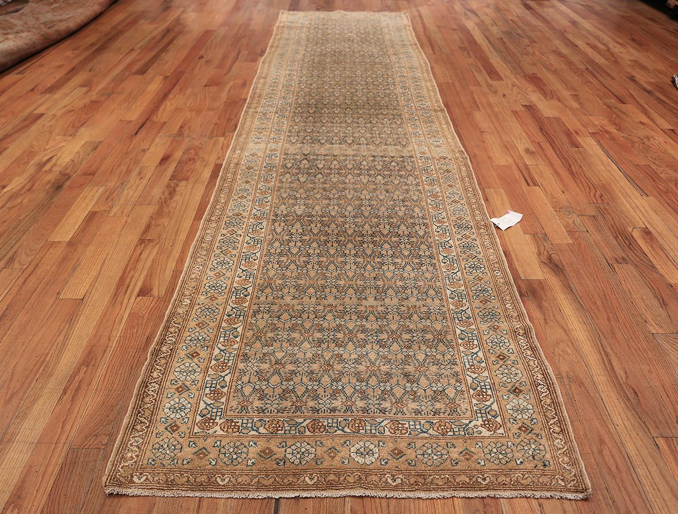 Antique Persian Malayer Runner Rug, Country of Origin: Persia, Circa Date: 1920. Size: 3 ft 7 in x 16 ft (1.09 m x 4.88 m)

This Persian rug is rendered in warm orange hues and complemented by deep blue-black line-work, depicting a repeating pattern