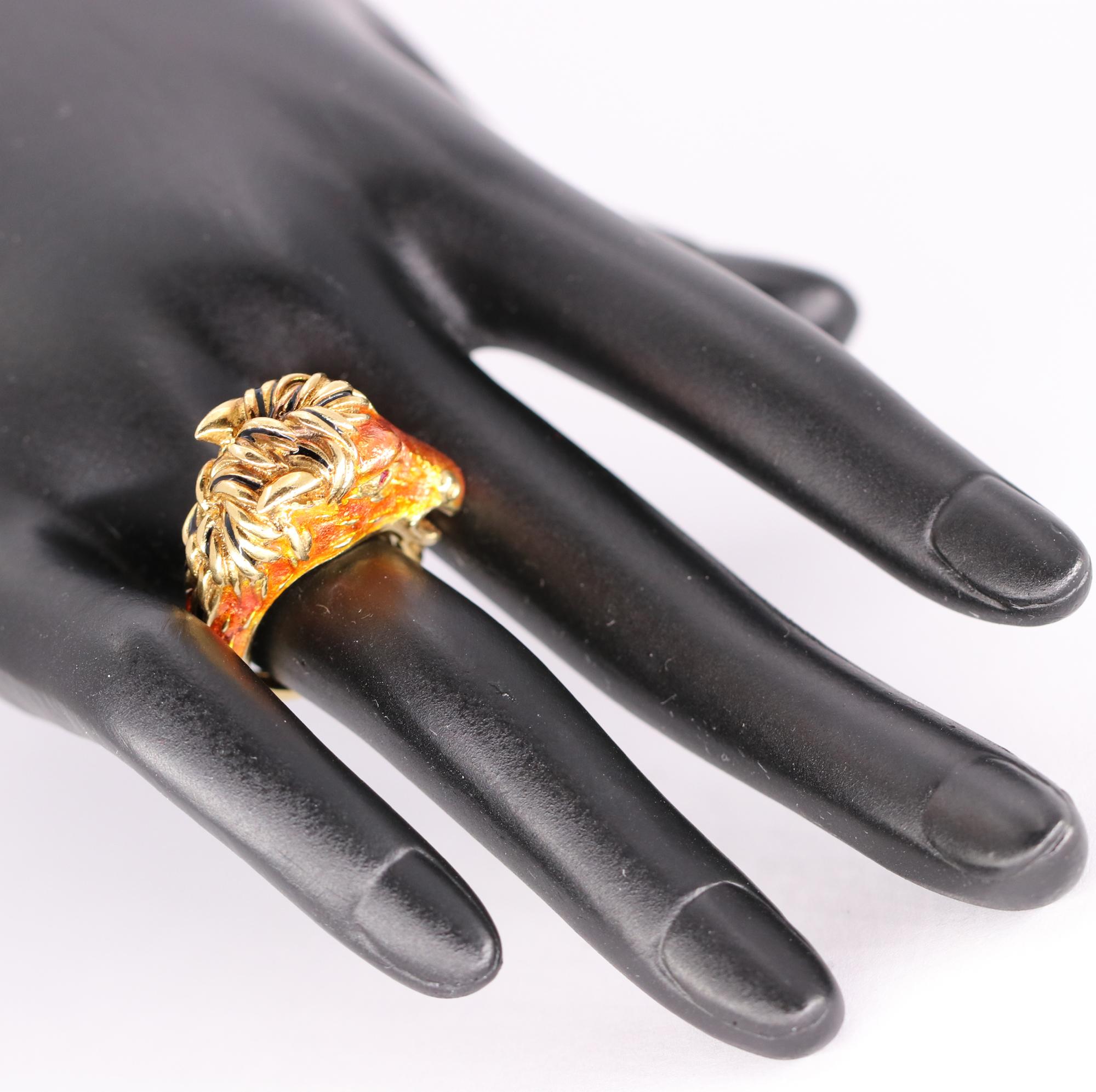 An 18K yellow gold ring with the power and design of a stallion, complete with a flowing gold mane and tail with black enamel accent. The face is a bright copper colored enamel with ruby eyes. Designed by Frascarolo of San Remo Italy, in the mid
