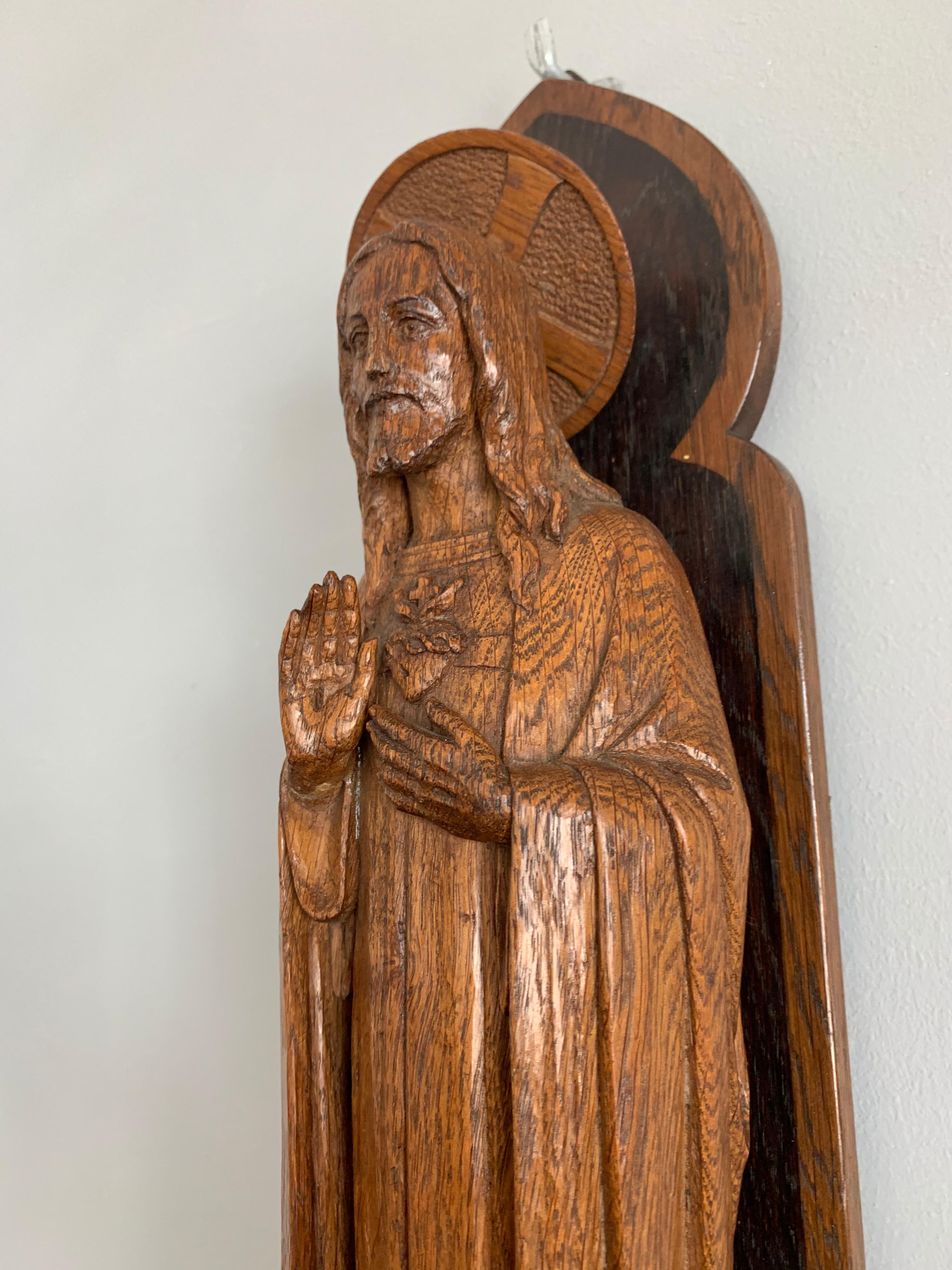 Quality carved Christ sculpture on original, Gothic Revival Console with illuminating cross lightbulb!

This carved oak, sacred heart statue is one of the most beautiful examples we have ever had the pleasure of offering. The beauty is not only in