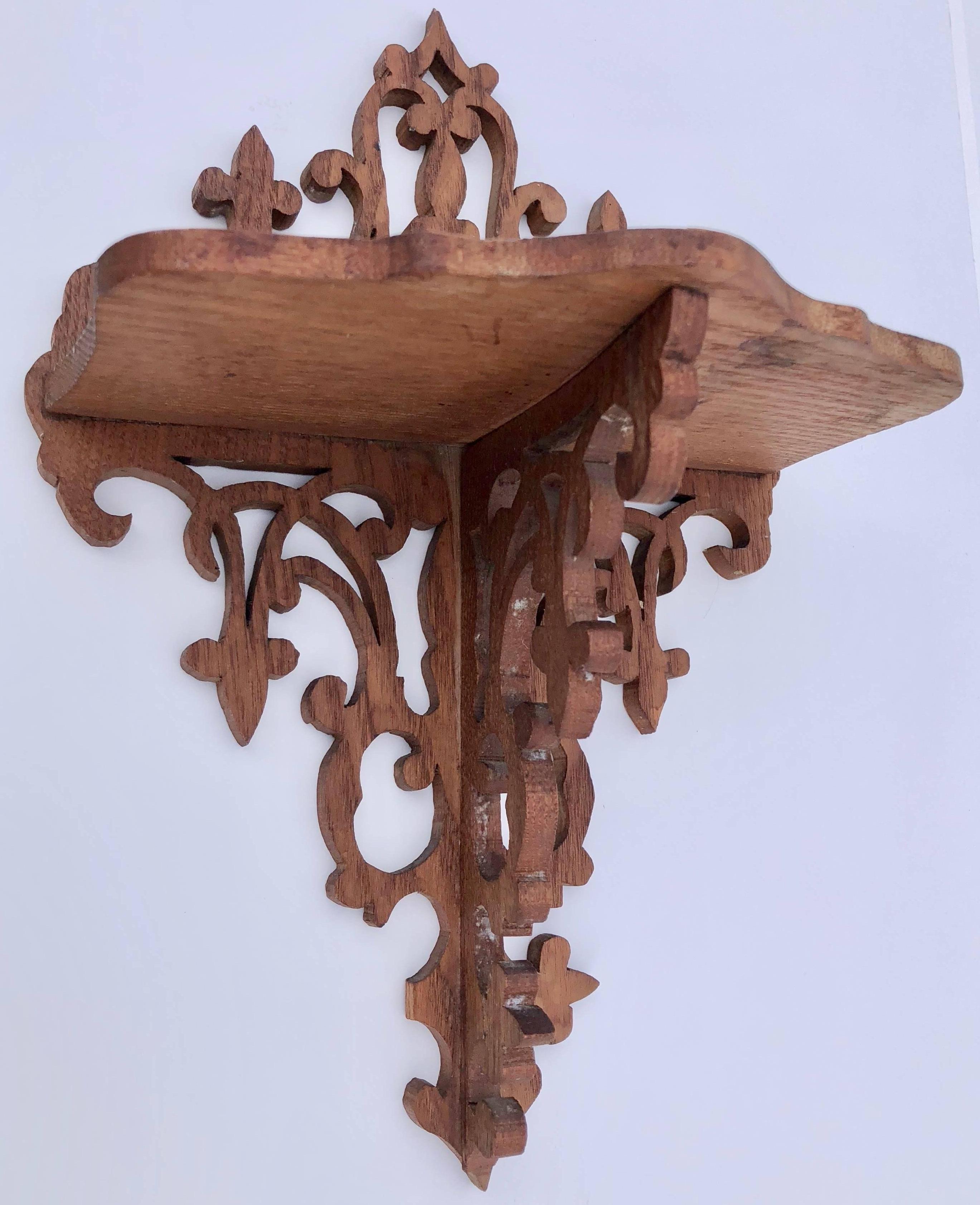 This beautiful hand carved wood wall sconce has an exquisite design and a shelf. It would be a perfect display for any small work of art or decorative object.

          