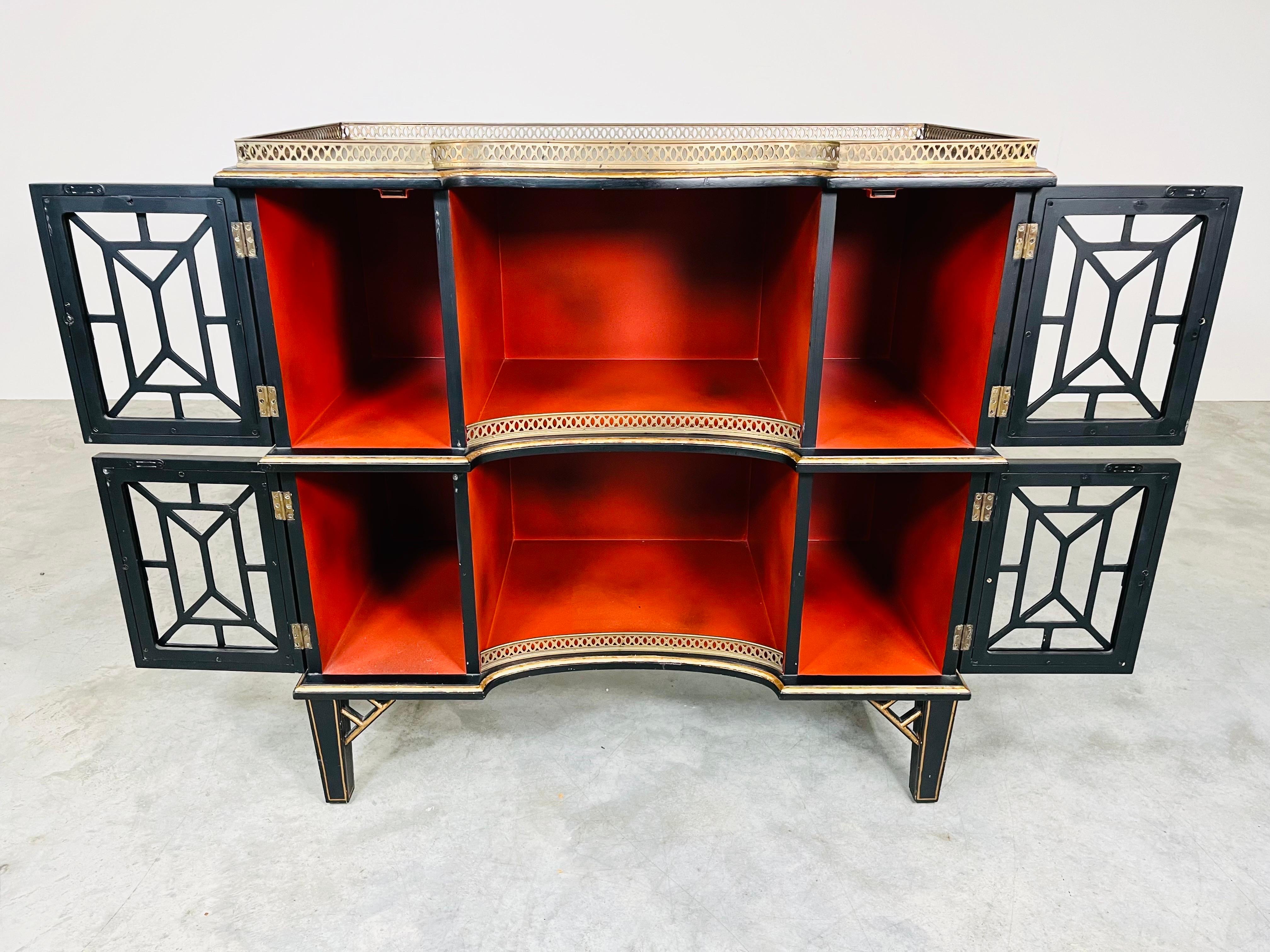 A beautiful multifunctional J & G Stickley Etagere, Bookcase or Console Table having carved Chinoiserie details throughout with brass gallery. Features 4 doors with 12” high shelf storage on both tiers having Chinoiserie brass pulls. 
 Leveled on