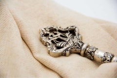 Detailed silver key with reliefs and cut-out galleon