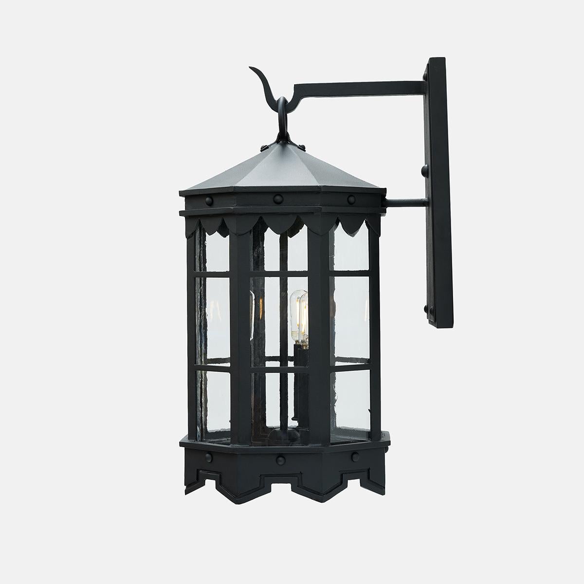 Our De La Guerra lantern finished in our premium dark zinc finish has Mediterranean style precedence with historic profiles and contemporized geometric lines. A striking fixture during the day but even more so at night when the patterned hem casts