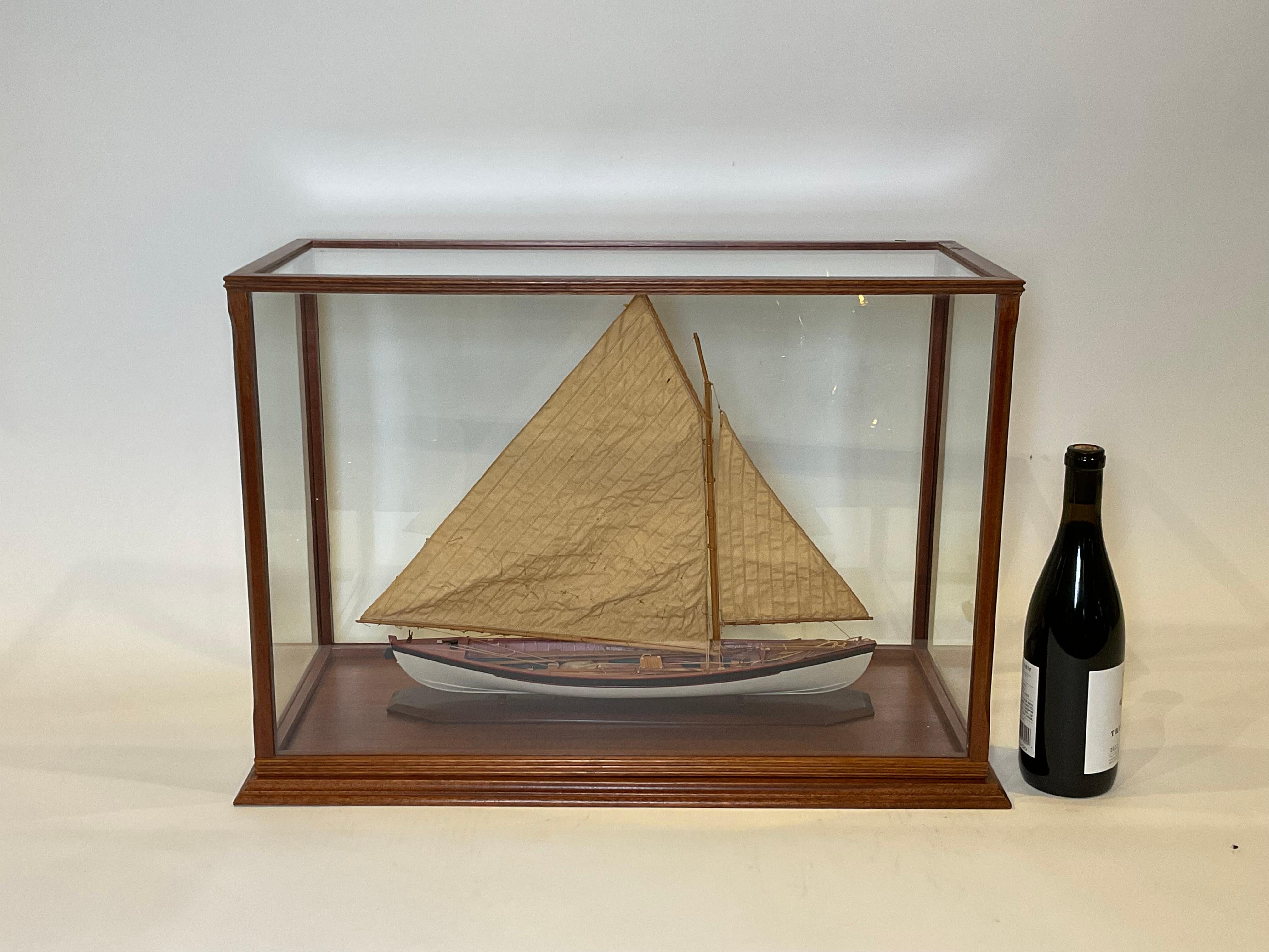 Sleek model of a whaleboat, rigged with a fine pair of finely stitched sails. Fully equipped with gear, including line tubs, an anchor, harpoons, lances, a water cask, flag, oars, etc. The oars are stored on deck. Fitted to a fine custom