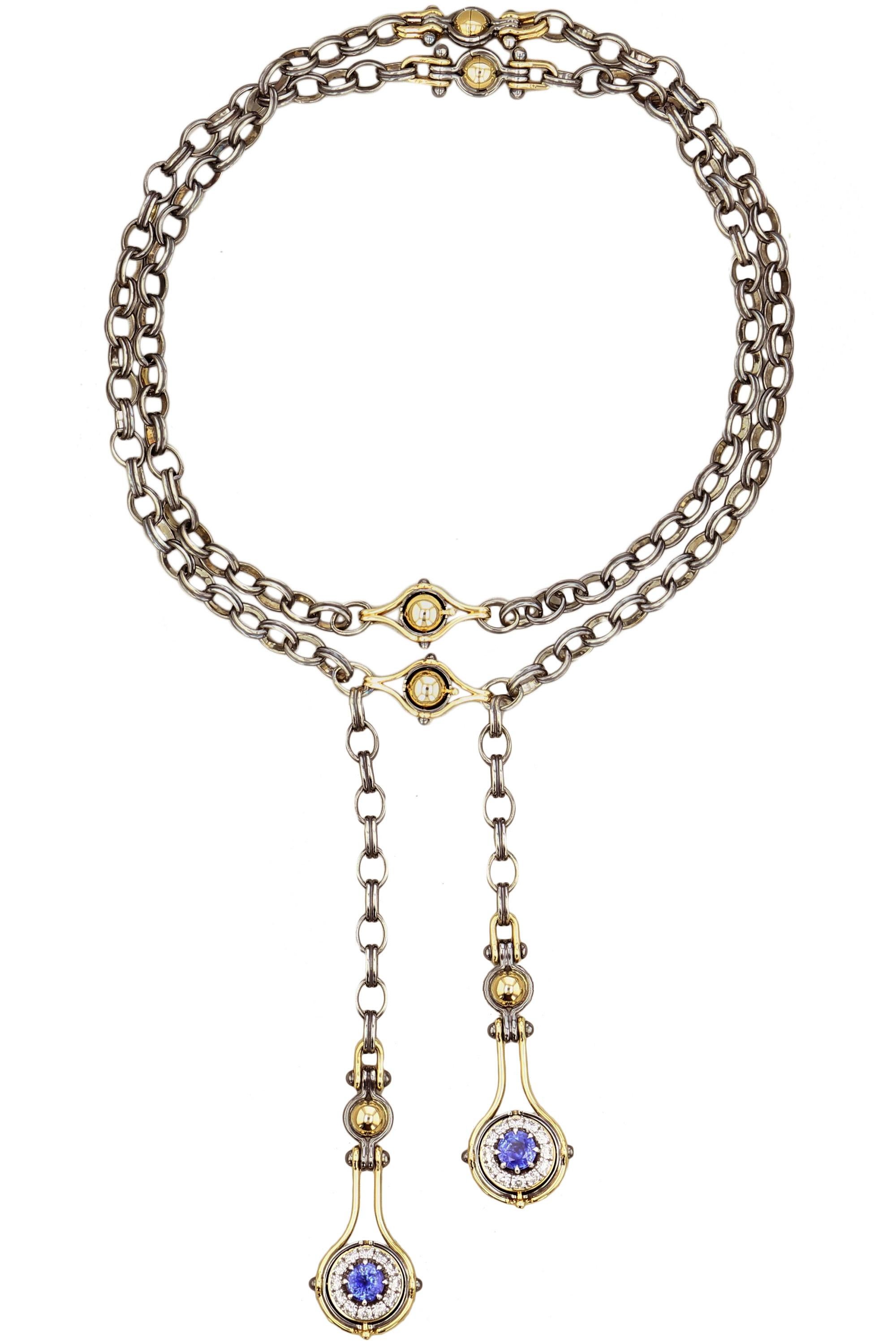 Adjustable necklace in yellow gold and distressed silver. Rotating spheres revealing a sapphire surrounded by diamonds.

Distressed silver chain with two clasps.

Details:
Central Sapphires : 3.31 cts
48 Diamonds :  2 cts 
18k Yellow Gold : 49