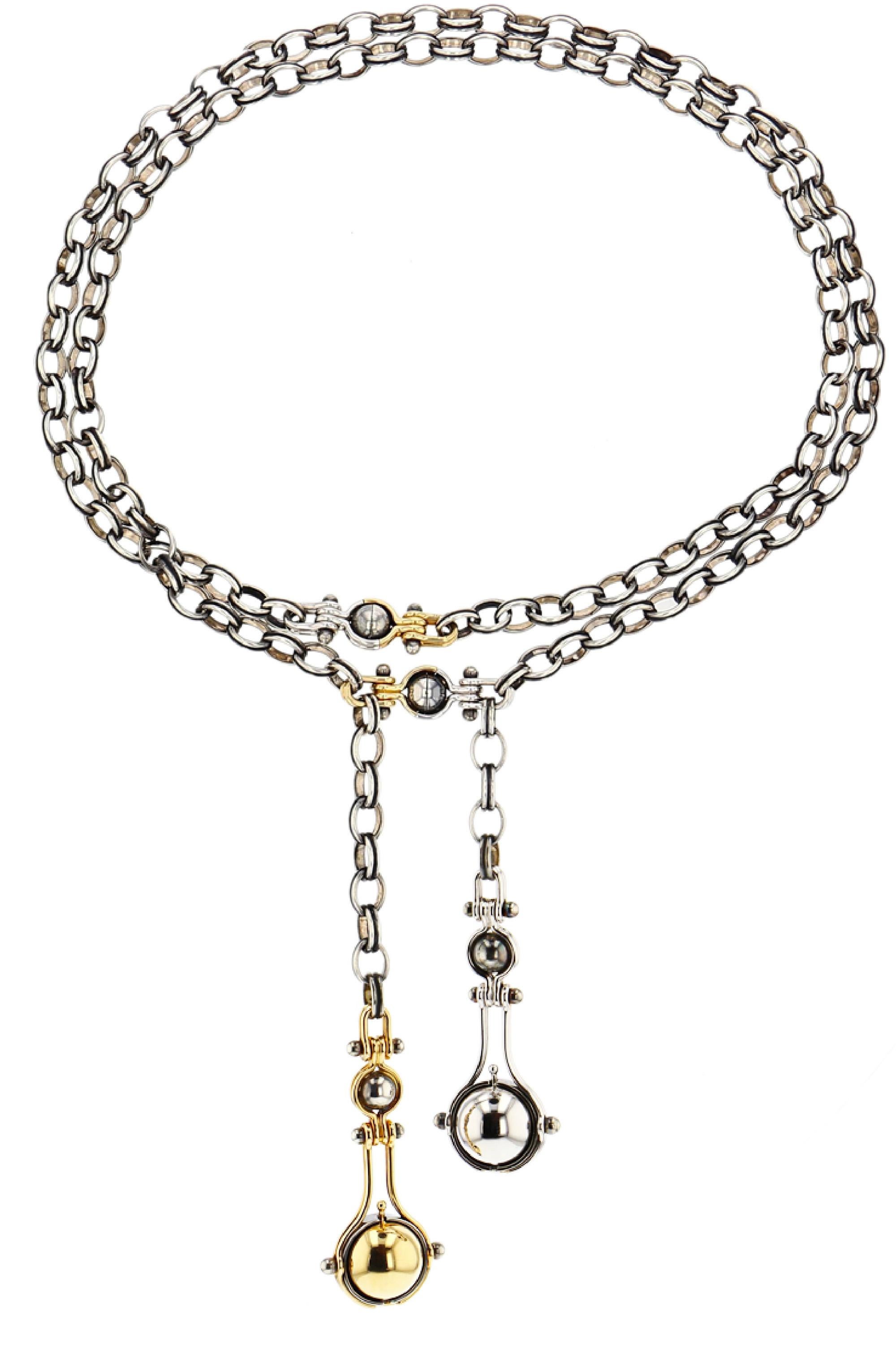 Necklace in gold and distressed silver. Rotating spheres: one reveals an Akoya pearl, set with a diamond and encircled by a white gold ring; the other reveals a Tahitian pearl, set with a diamond and encircled by a black gold ring.

Distressed