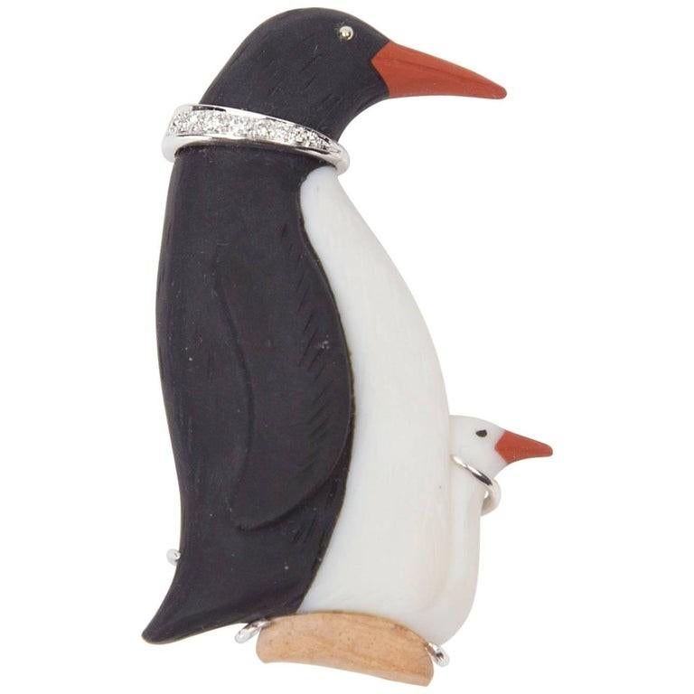 This Delightful Penguin mother and chick make an elegant and charming brooch. Hand crafted in Onyx, Carnelian and 14K white Gold and enhanced with sparkling diamonds in the neck. This whimsical and charming pin measures approximately 2