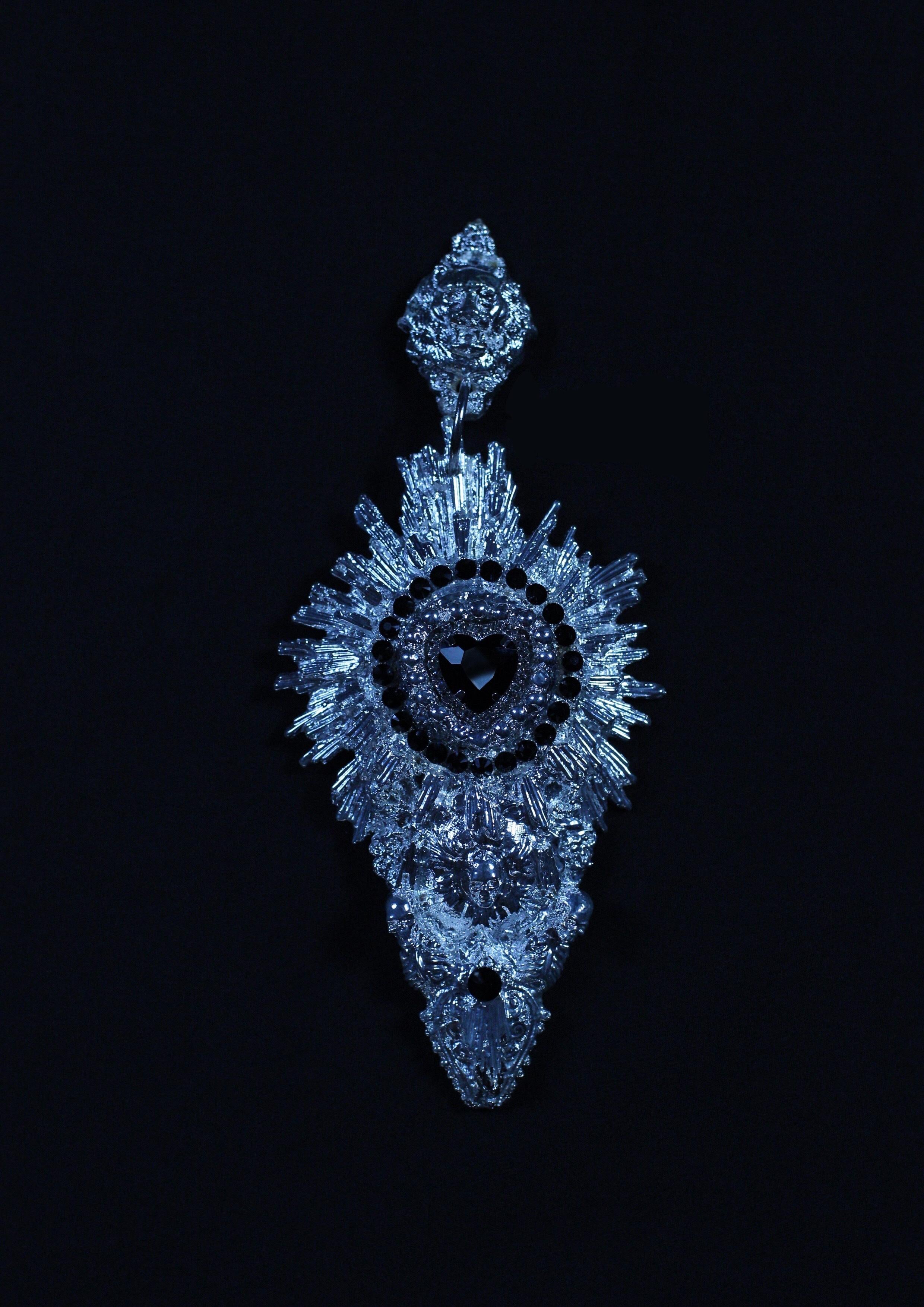 Devotion Earrings by Angelis Blade

These stunningly intricate statement earrings embody Angelis Blade’s dedication to luxury craftsmanship. The Devotion earrings, the largest design to date, radiate elegance with a heart-shaped, faceted glass