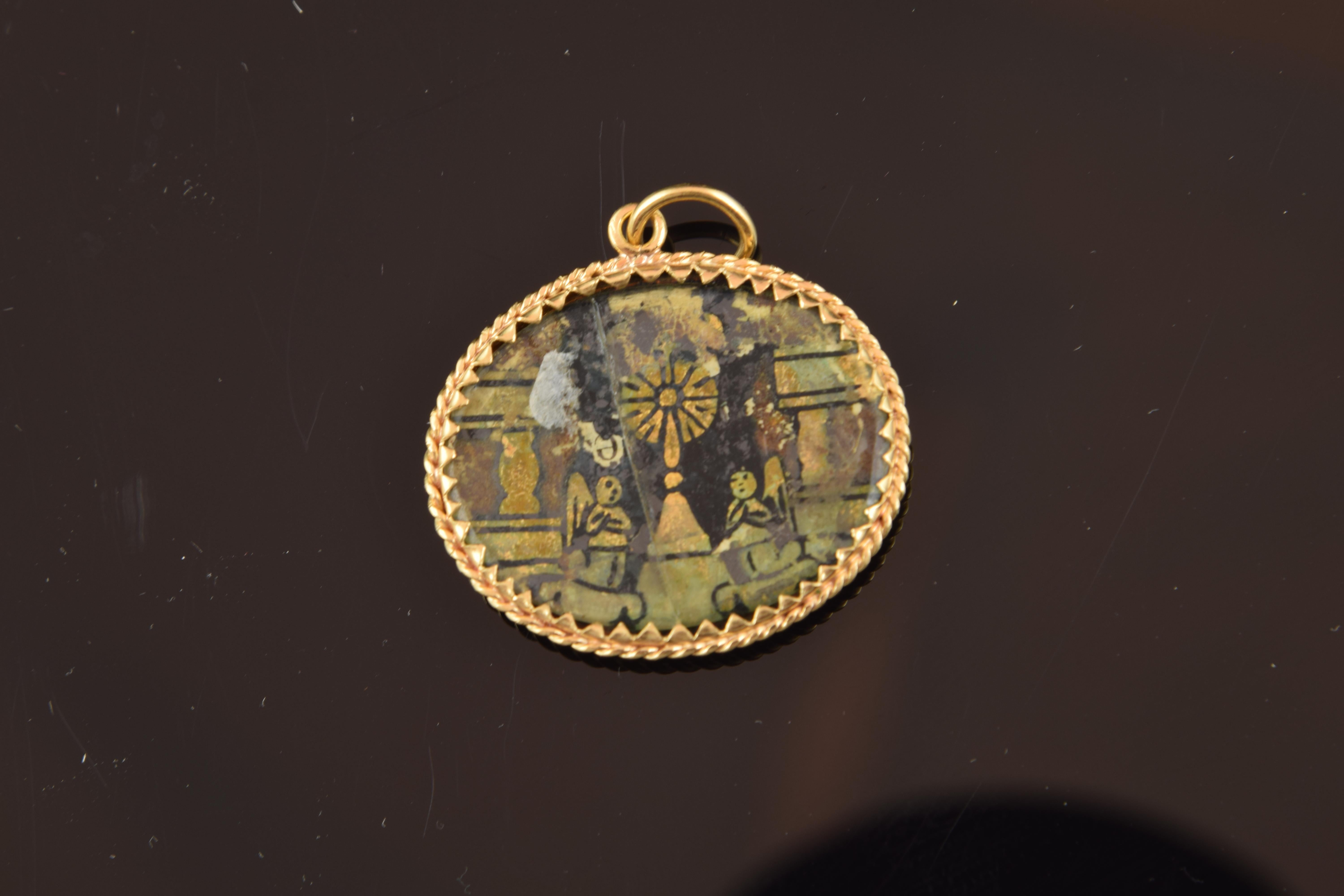 Oval devotional enamel pendant showing Saint Catherine (with a palm in one hand and a Cross of Jerusalem on a white flag in the other) and a monstrance located on an altar flanked by two angels.