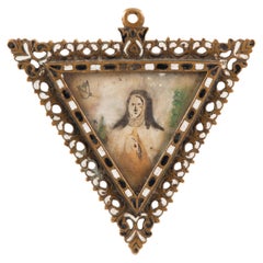 Devotional pendant, Saint Teresa of Ávila. Bronze, enamel, etc. Spanish School.