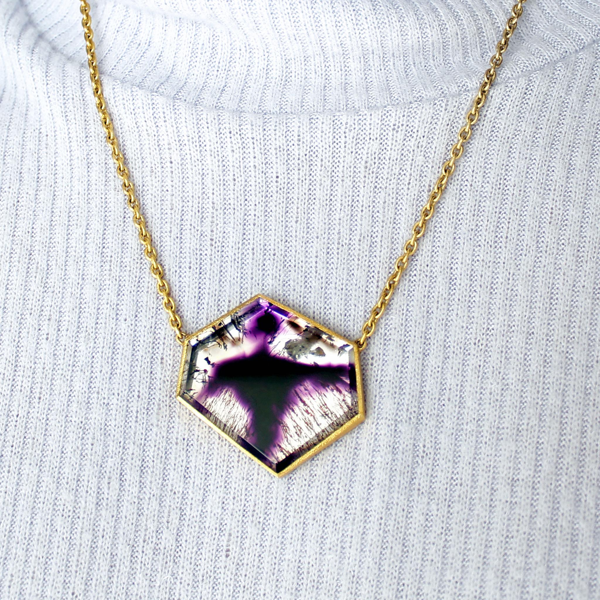 One of a Kind Amethyst Shadow Necklace handcrafted by jewelry maker Devta Doolan in signature-finished 22k yellow gold showcasing a remarkable gemstone with an extraordinarily-rare growth formation of amethyst within a quartz crystal, complemented