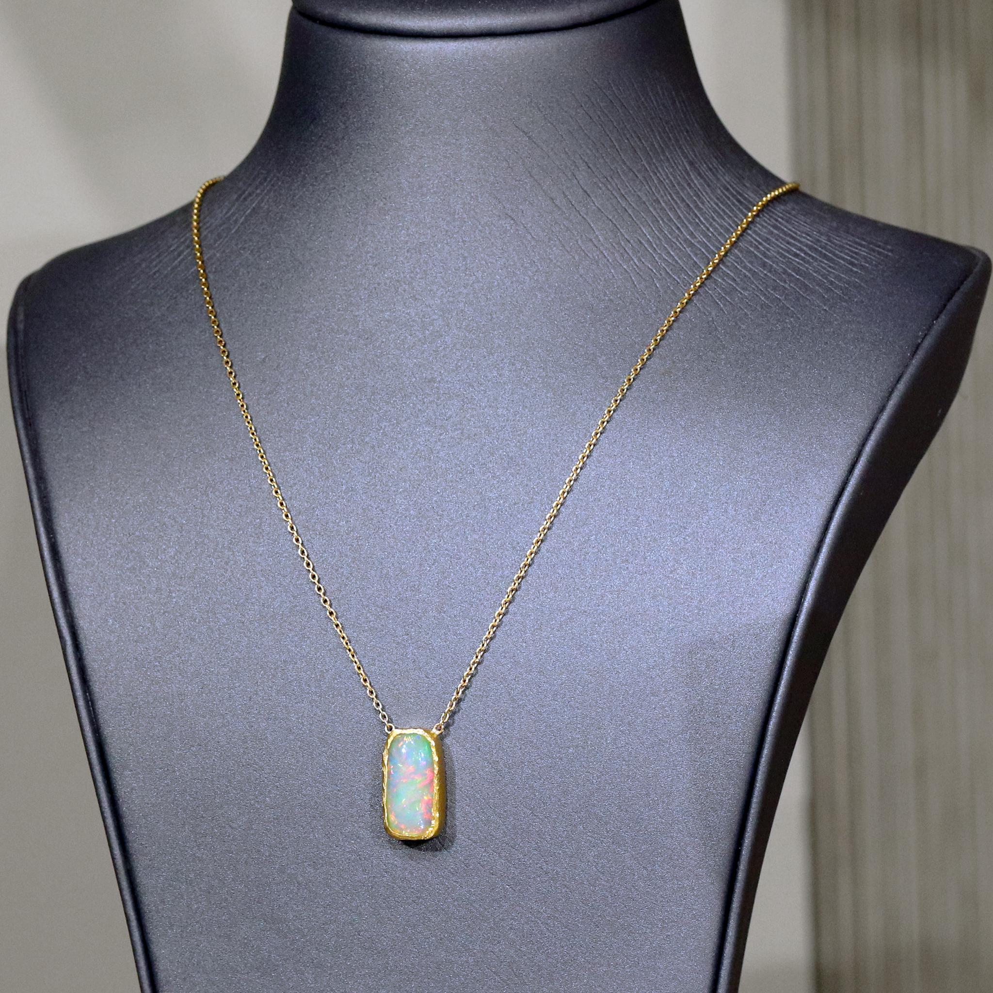 Gem Opal Fire Necklace by acclaimed jewelry maker Devta Doolan showcasing an exceptionally fine quality 20mm x 9mm solid gem crystal Ethiopian opal cabochon with remarkable rainbow flash, fire, and color change. The gem opal is hand-fabricated in