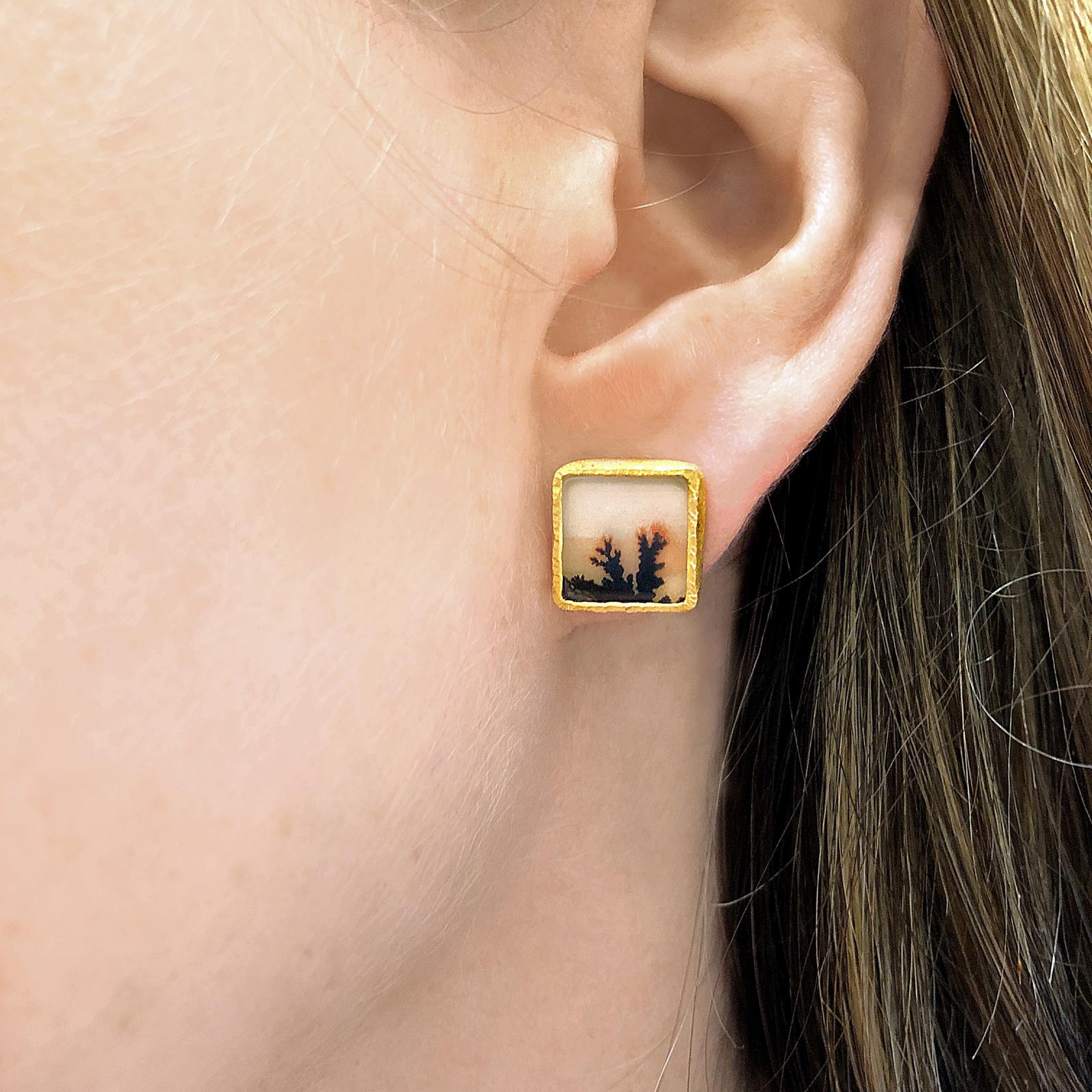 One of a Kind Stud Earrings hand-fabricated by jewelry maker Devta Doolan in a the artist's signature-finished 22k yellow gold showcasing a stunning matched pair of natural dendritic agate and finished with a pair of 18k yellow gold posts and backs.