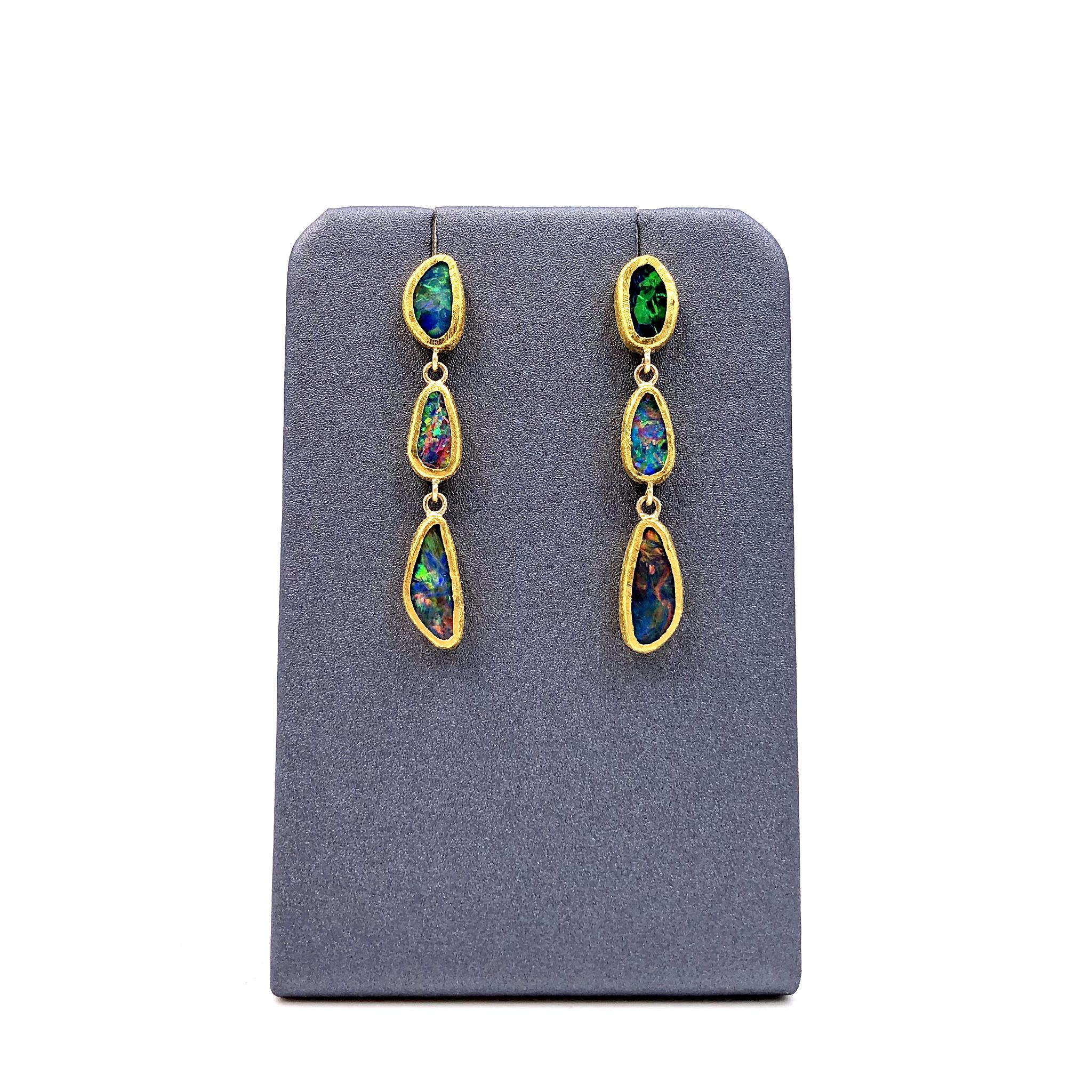 One of a Kind Drop Earrings handcrafted by acclaimed jewelry maker Devta Doolan with six opal doublets exhibiting a vibrant multicolored confetti flash - electrifying red, green, orange, blue, yellow, violet, and purple fire. The opals are bezel-set