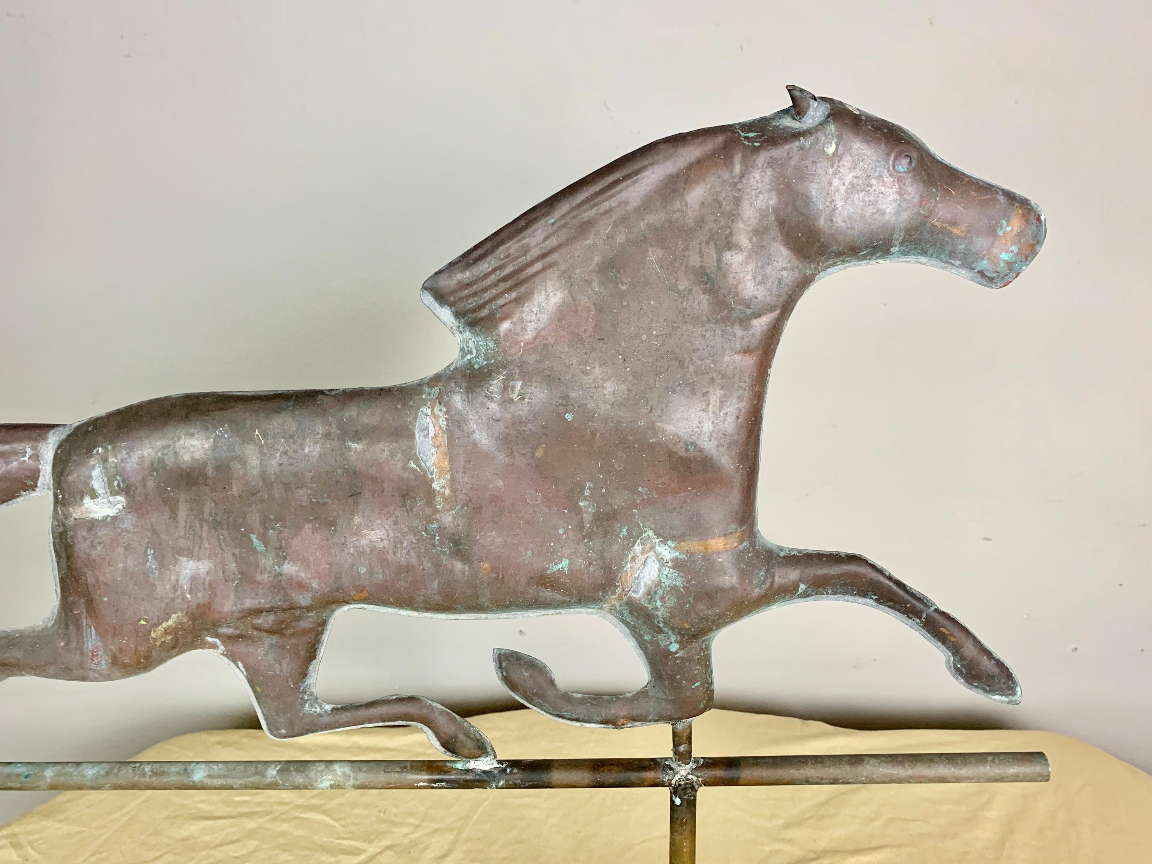 Dexter copper horse from a weathervane. The horse has been mounted on a steel base and is a perfect accent piece for a fireplace mantel and more.