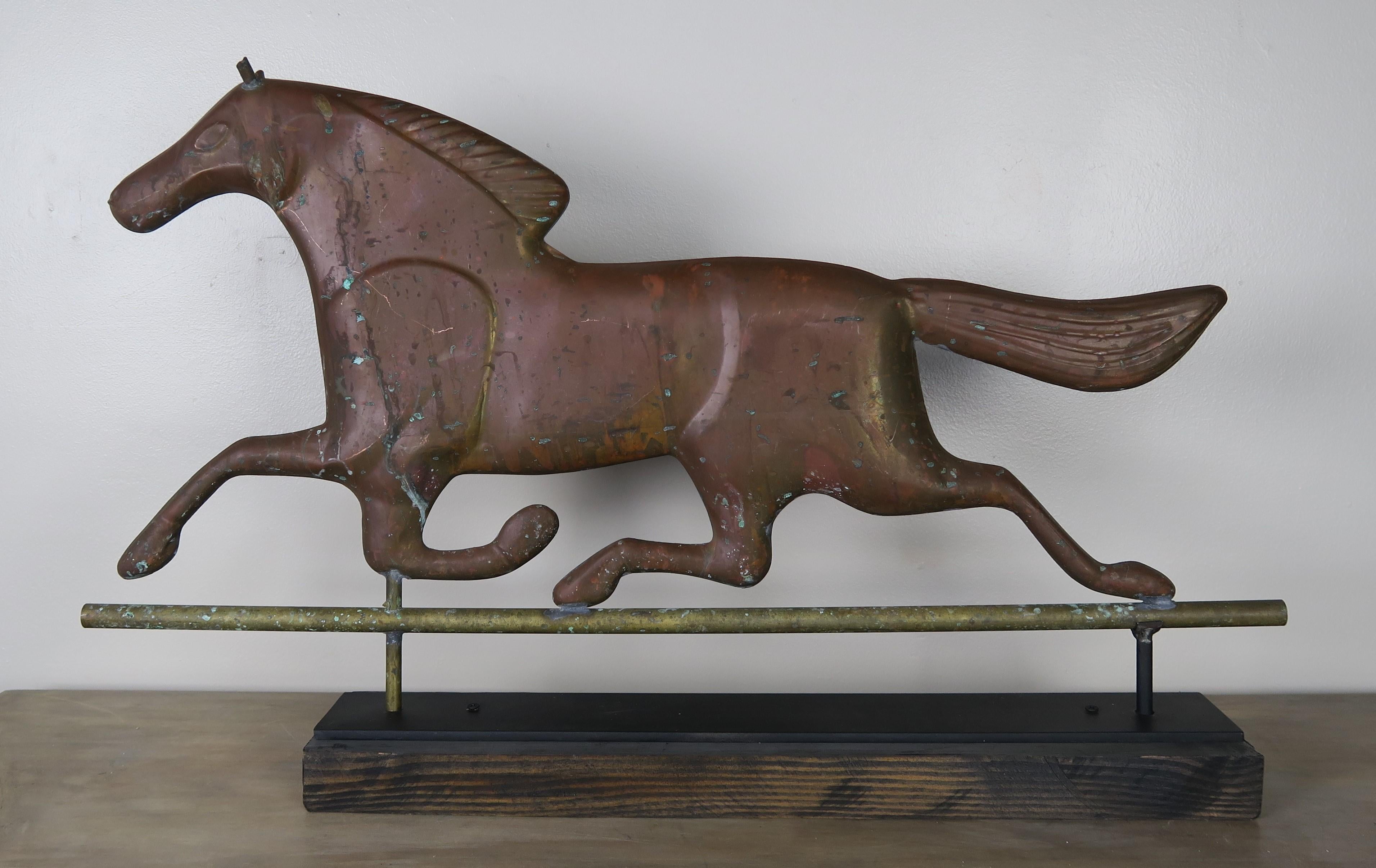 Dexter horse weathervane mounted on iron base. The copper horse was originally done in gold leaf but has weathered over the years given the piece a beautiful patina.